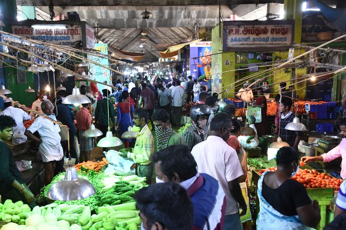 Lorries from various places arrive at the market a little after midnight to unload vegetables and other supplies after which the wholesale market comes to life at about 4 am. (DH Photo)
