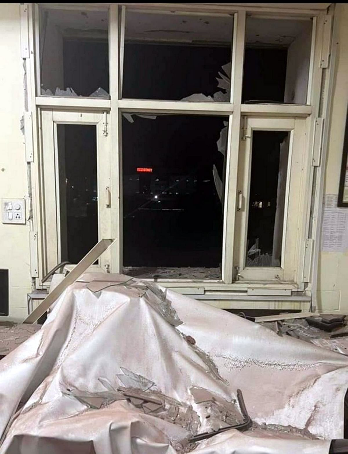Damaged window of the Punjab Police's intelligence department office after a blast outside the office, in Mohali. Credit: PTI Photo
