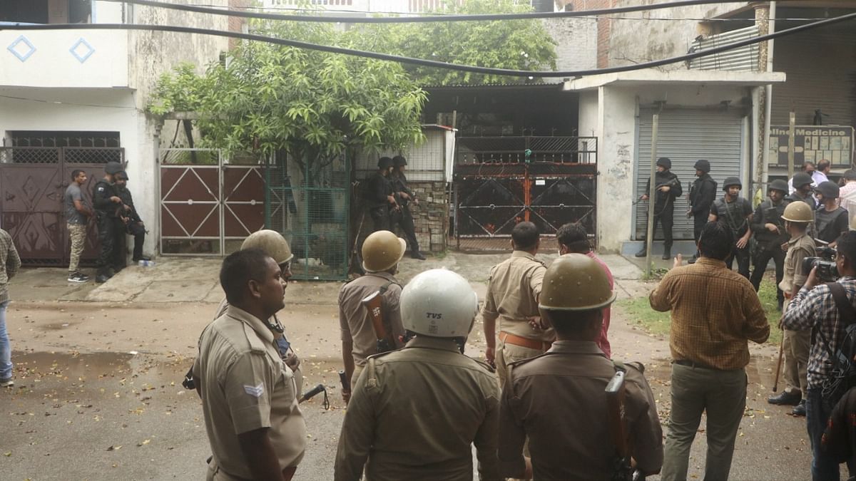 Uttar Pradesh Anti-Terrorism Squad (ATS) personnel outside the house from where two accused allegedly linked with Al Qaeda module were arrested.