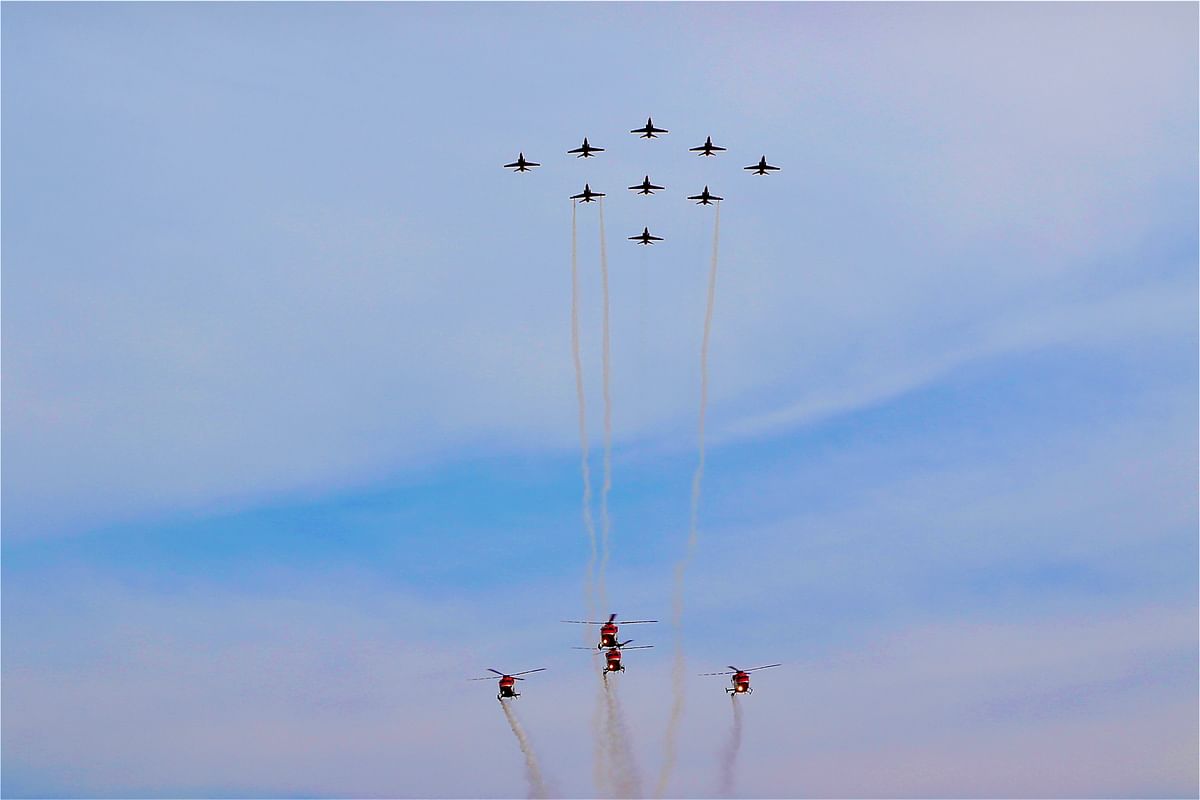 Sarang, the four-helicopter display team, and Suryakiran, the nine-aircraft aerobatic team, performing in the skies. Credit: Special arrangement