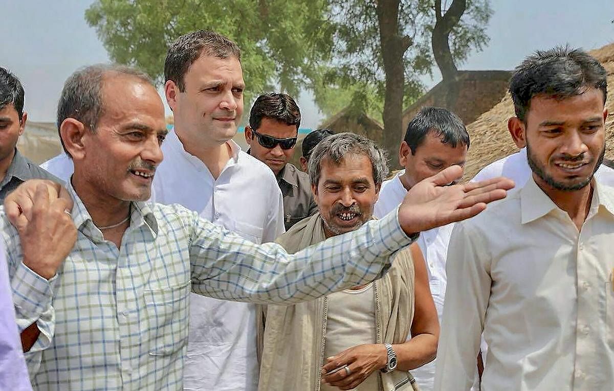 Congress President Rahul Gandhi interacts with farmers at Urer Mau village in his parliamentary constituency Amethi on Monday. PTI