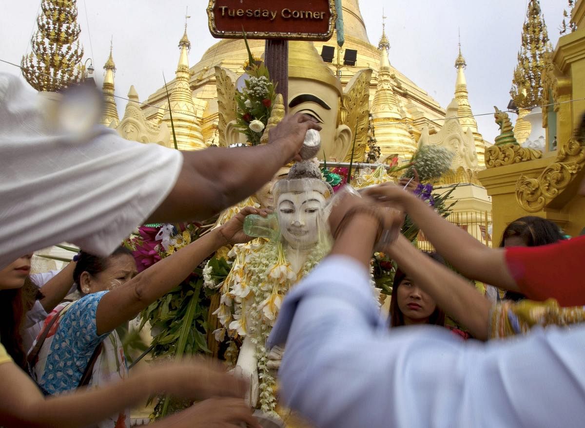 Buddhist devotees pour water to a Buddha statue at Myanmar famous Shwedagon pagoda to mark Myanmar traditional new year Tuesday, April 17, 2018, Yangon, Myanmar. AP/PTI
