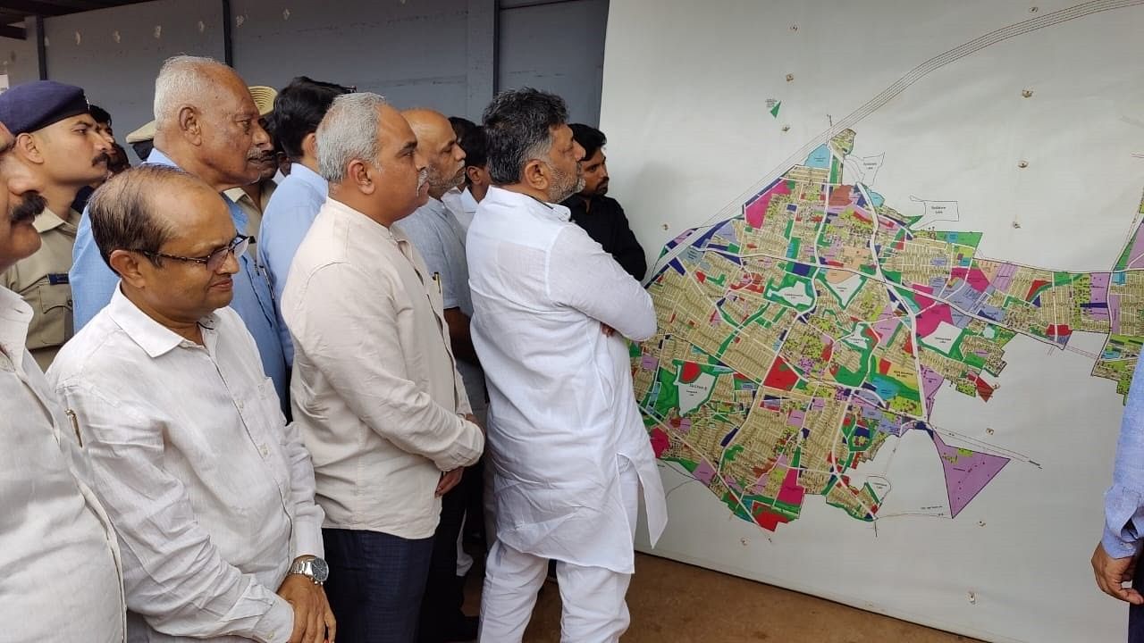 DyCM D K Shivakumar examines the layout map of SK Layout on Saturday.