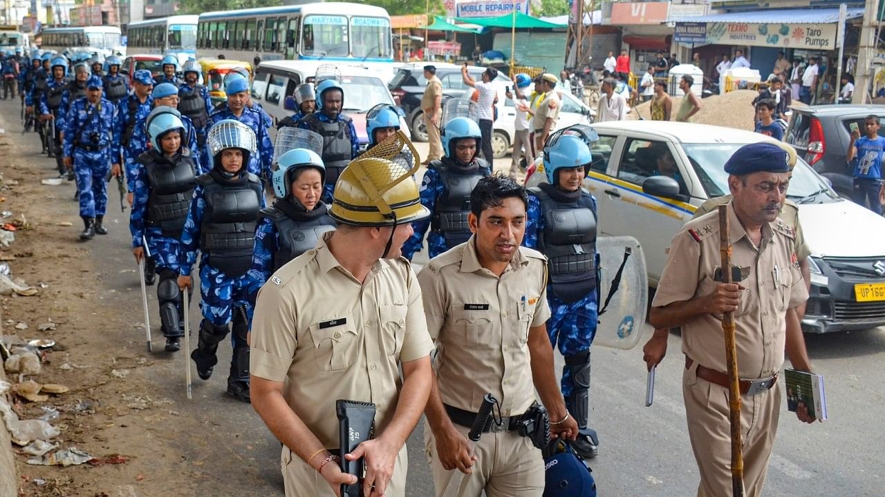 <div class="paragraphs"><p>Haryana Police and Rapid Action Force (RAF) personnel conduct a flag march at Badshahpur after incidents of violence in Nuh. </p></div>