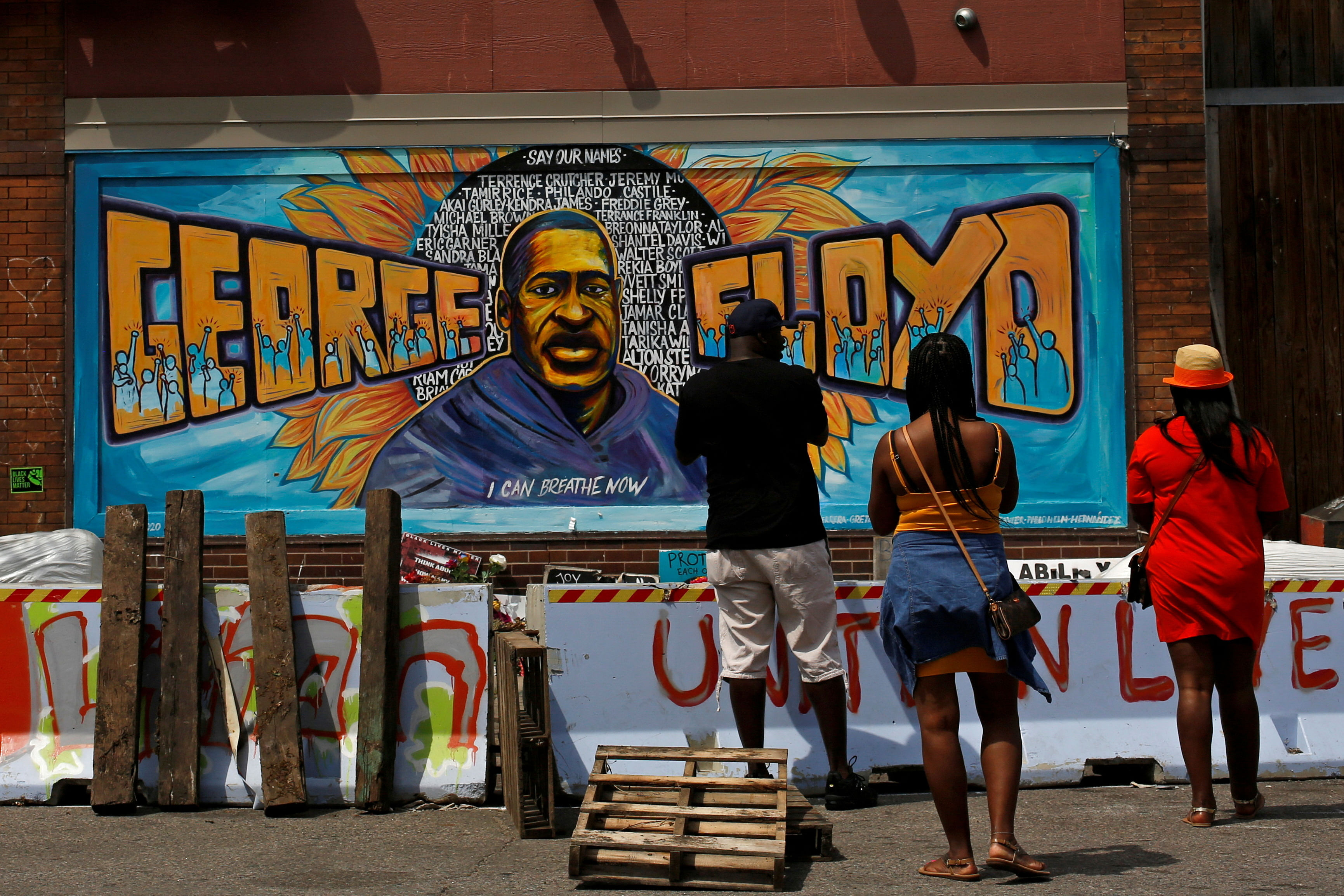 <div class="paragraphs"><p>File Photo: Community members visit one of the murals at George Floyd Square, now behind barricades that formerly blocked the street, after city employees began to reopen George Floyd Square, the area where George Floyd was killed in Minneapolis police custody the year before, in Minneapolis, Minnesota, US June 3, 2021.  </p></div>