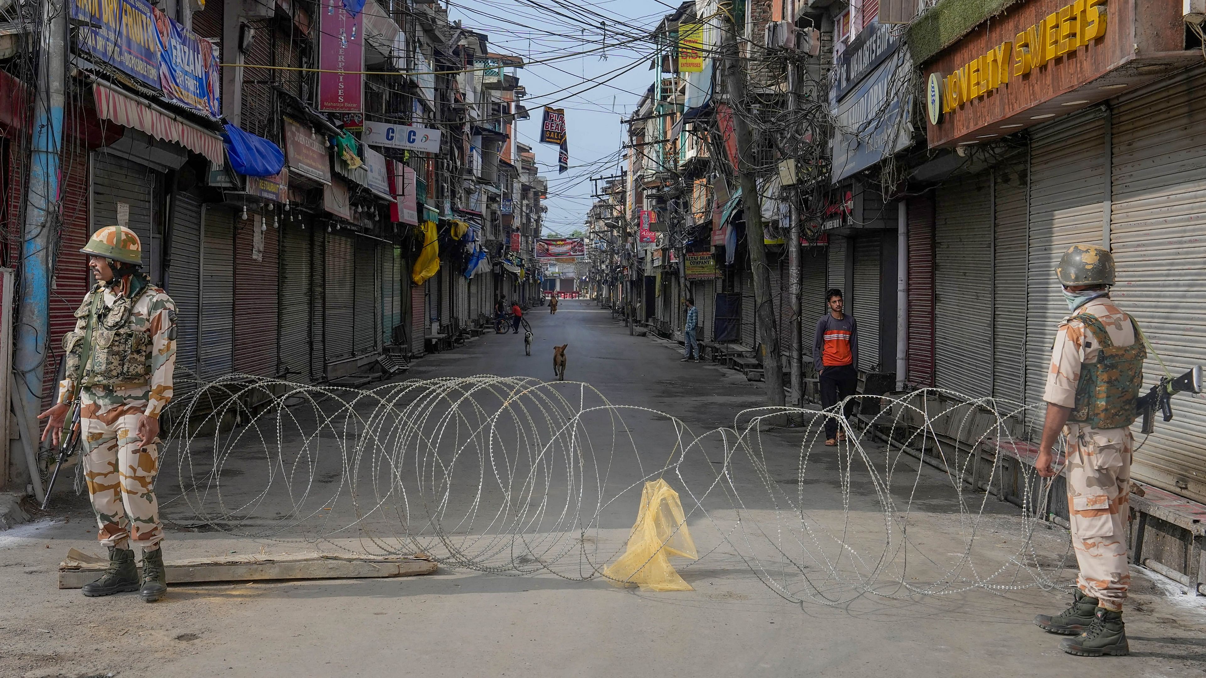 <div class="paragraphs"><p>Srinagar: Security personnel stand guard at a closed streeet during the 77th Independence Day celebrations at Bakshi Stadium, in Srinagar, Tuesday, Aug. 15, 2023.</p></div>