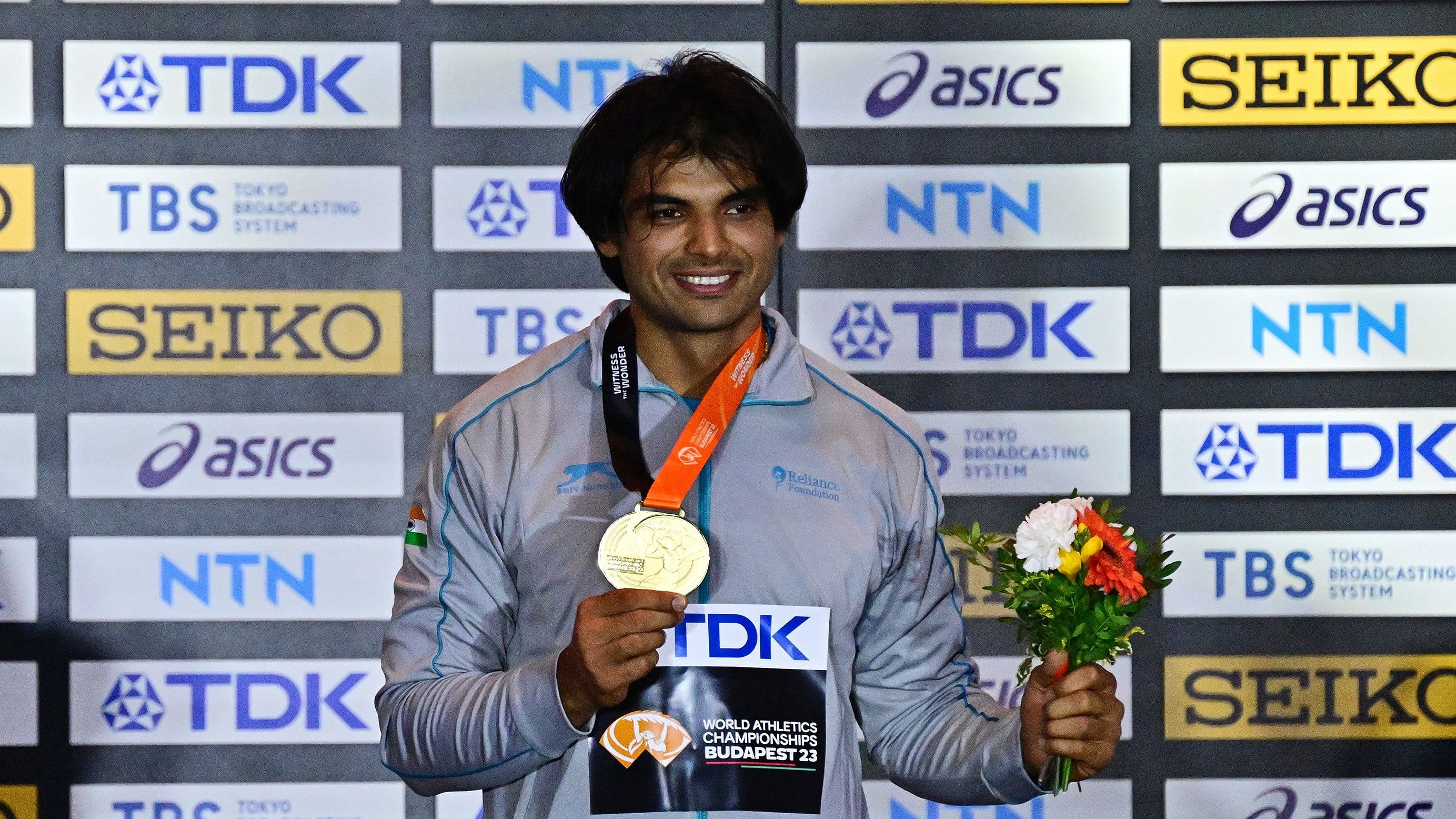 <div class="paragraphs"><p>India's Neeraj Chopra celebrates on the podium with his medal after winning the World Athletics Championship final.</p></div>