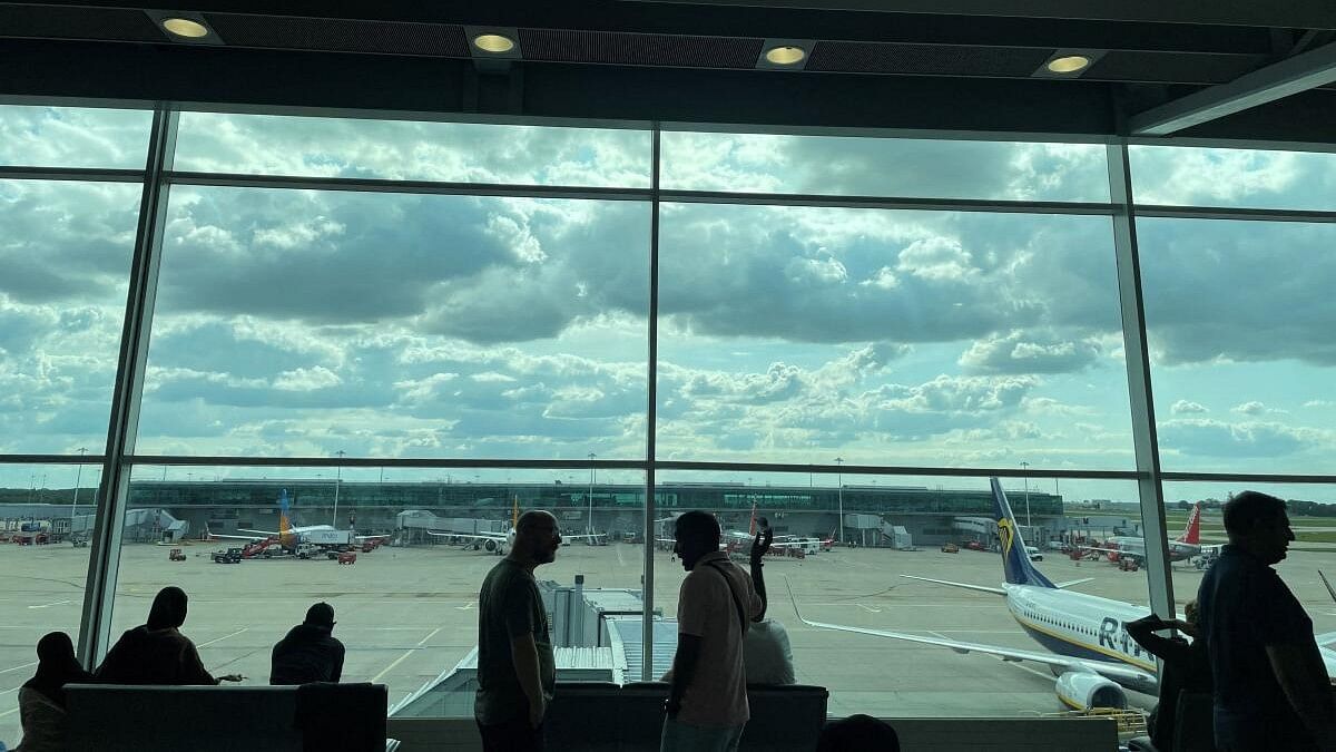 <div class="paragraphs"><p>Passengers awaiting news on cancelled or delayed flights at London Stansted Airport gesture as they discuss the situation on Monday, in Stansted, Britain August 28, 2023.</p></div>