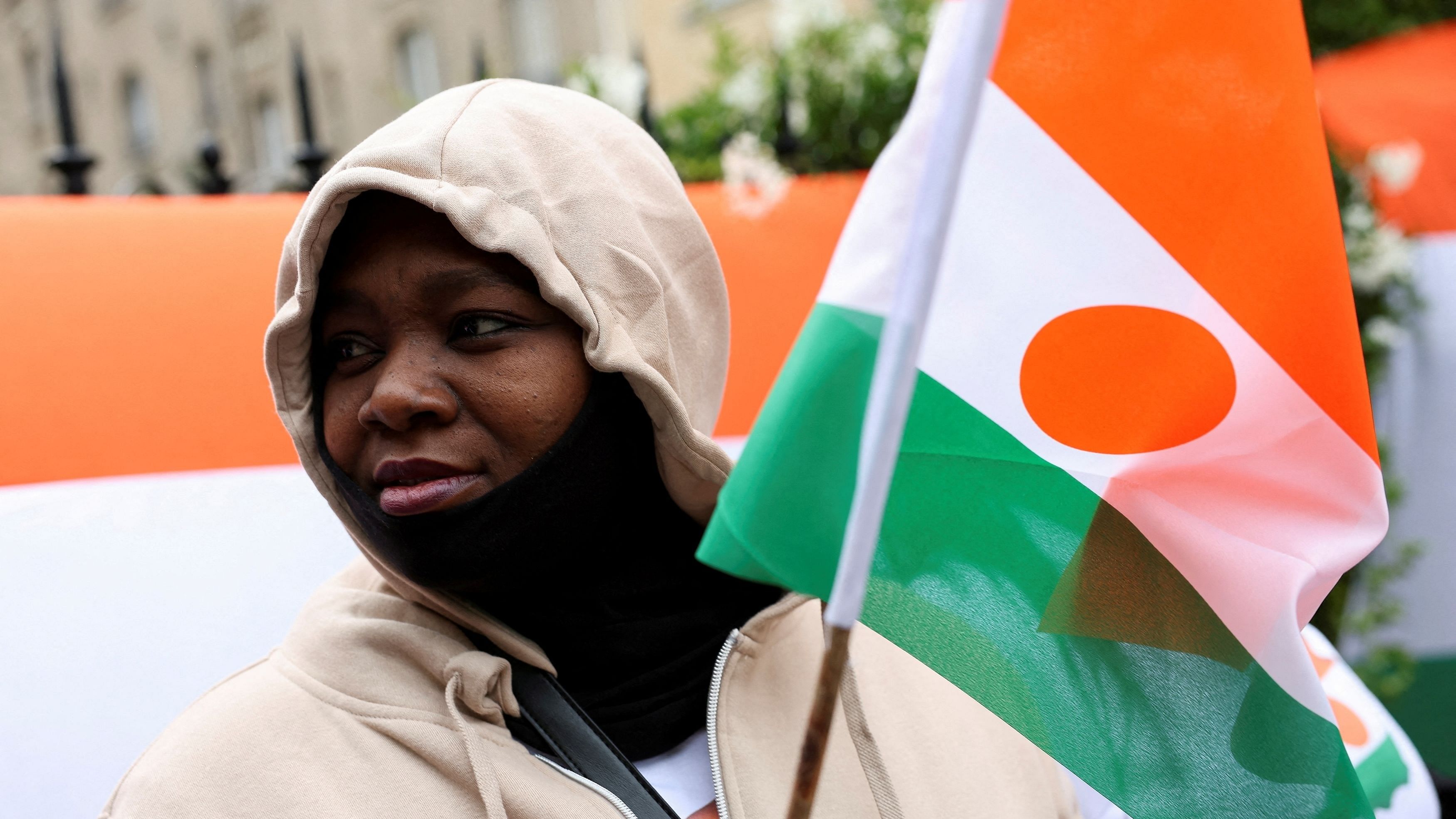 <div class="paragraphs"><p>FILE PHOTO: A person holds a Niger's flag outside Niger's embassy in support of the President of Niger Mohamed Bazoum in Paris, France, August 5, 2023. </p></div>