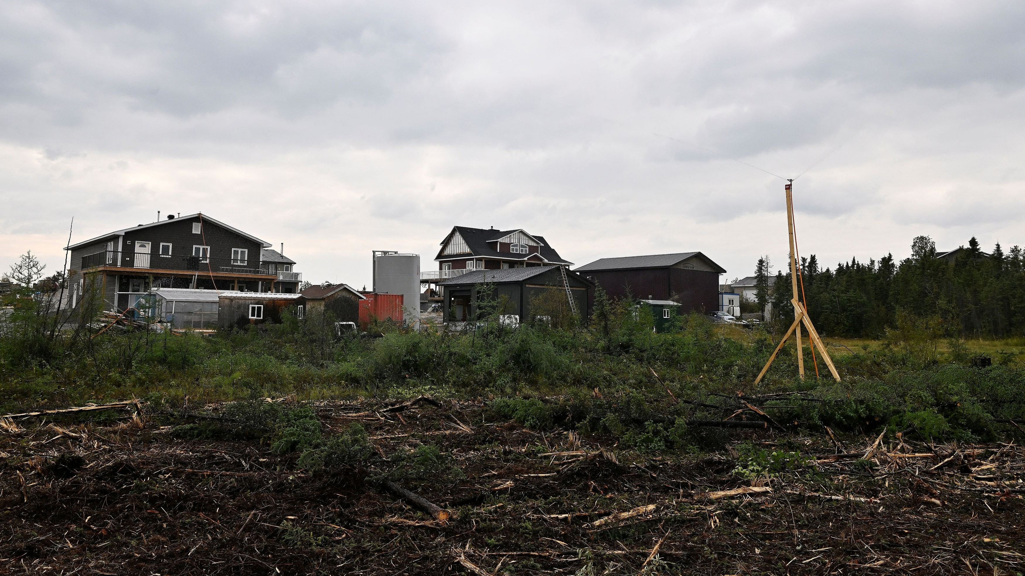 <div class="paragraphs"><p>Residents set up sprinklers and cut back grasses to protect their homes in the neighbourhood adjacent to Grace Lake as wildfires threatened the Northwest Territories town of Yellowknife, Canada, August 18, 2023.  </p></div>