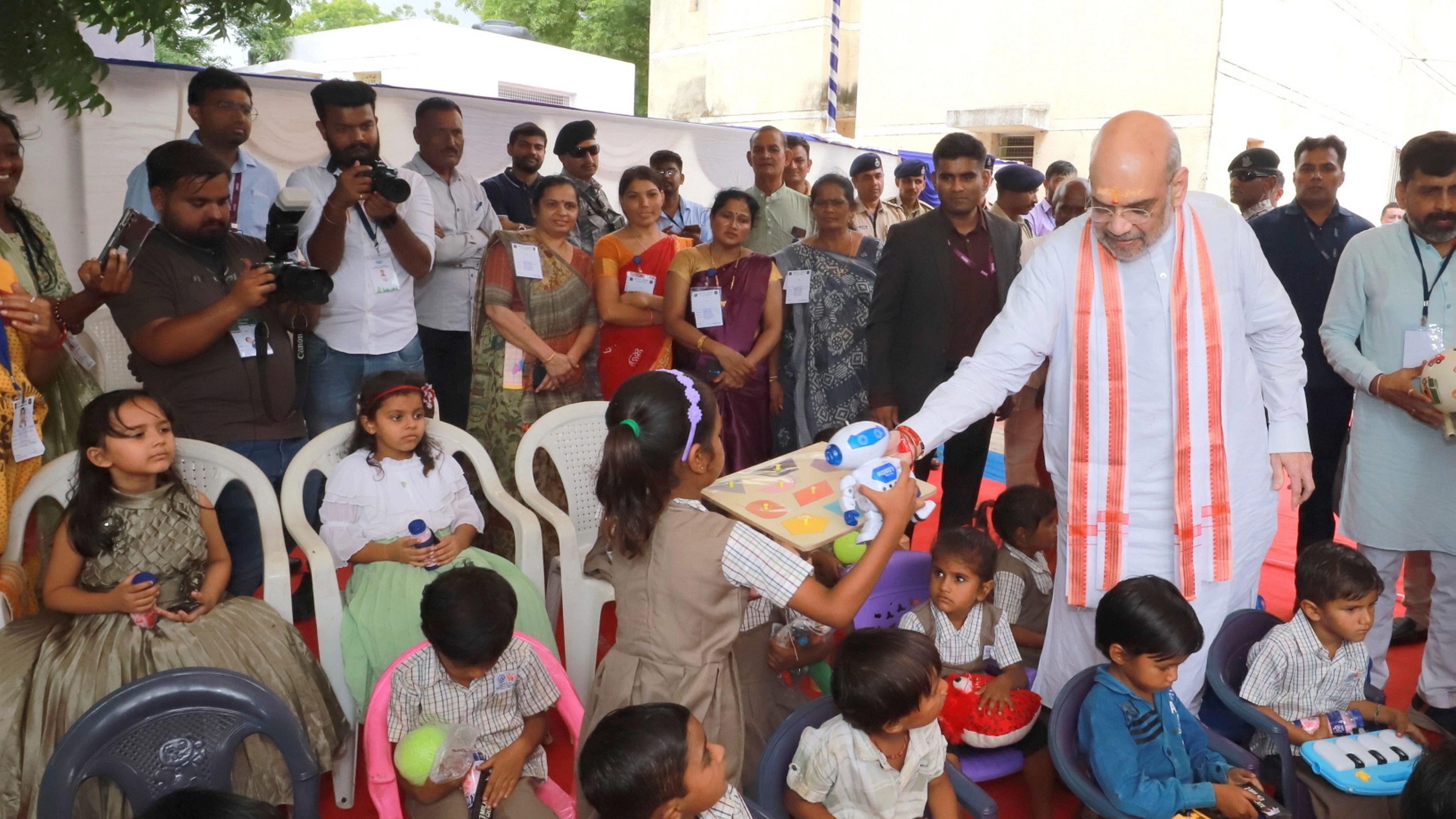 <div class="paragraphs"><p>Union Home Minister Amit Shah distributes toys to children at an Anganwadi, in Gandhinagar.</p></div>