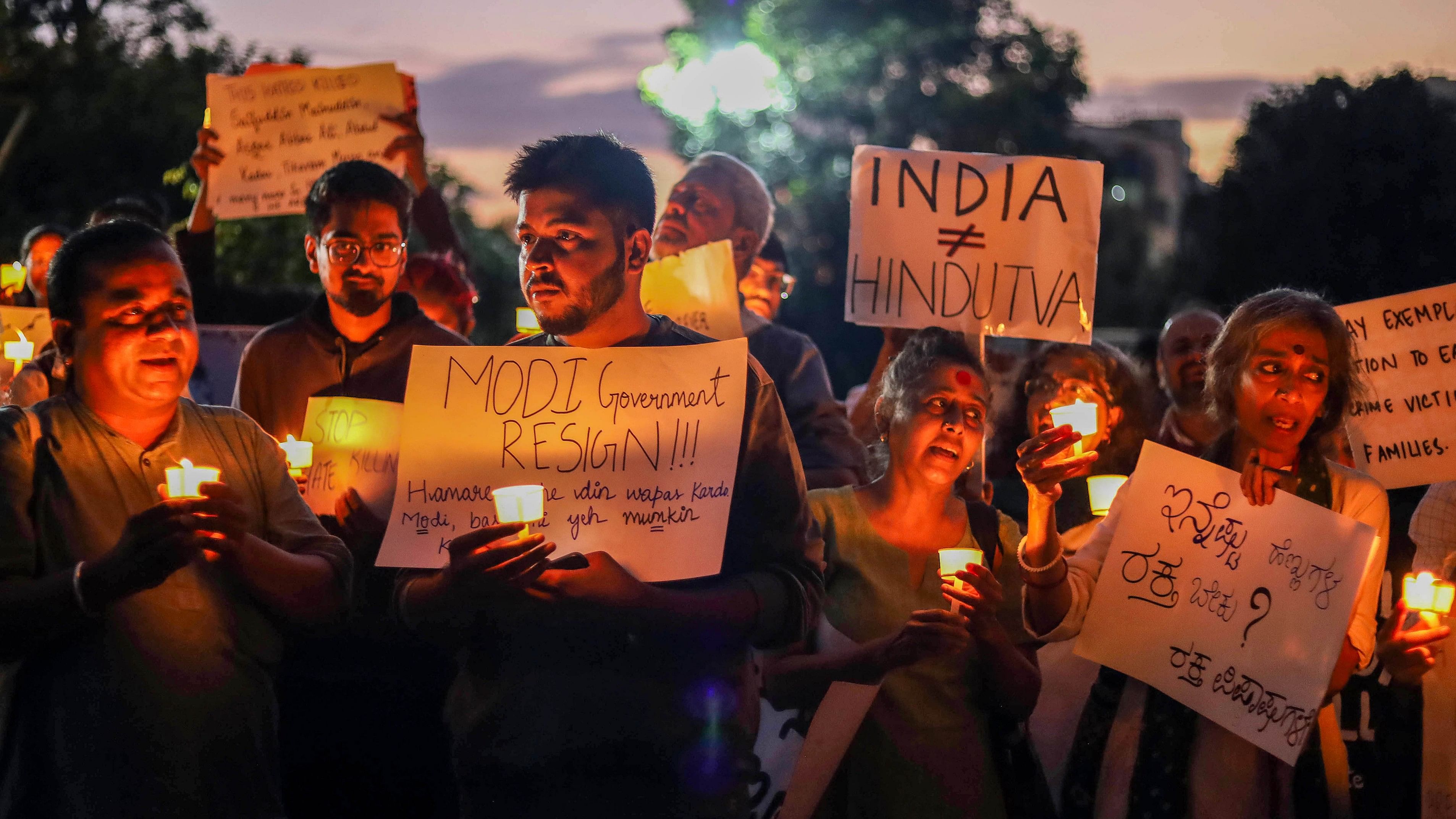 <div class="paragraphs"><p>Activists hold placards during a candlelight vigil while protesting against the central government condemning the atrocities on women and violence in Manipur and other issues.&nbsp;</p></div>