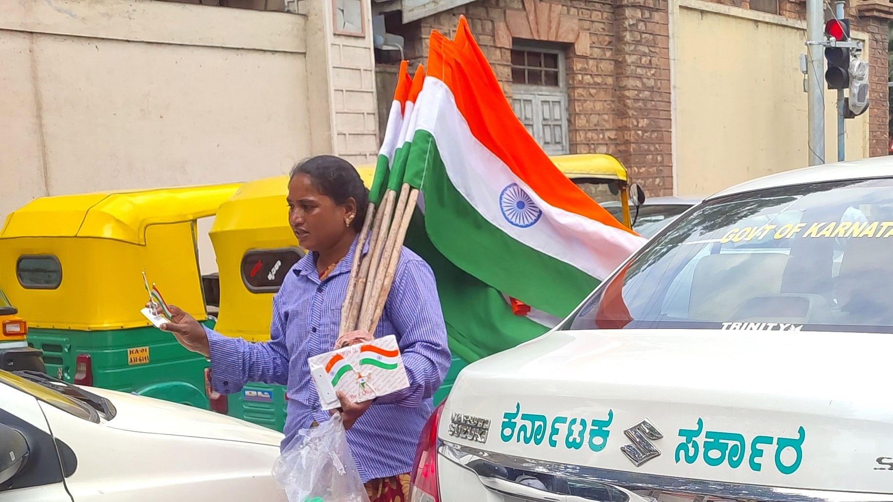 Ahead of Independence Day, a street vendor sells Indian flags at a traffic signal in the city.