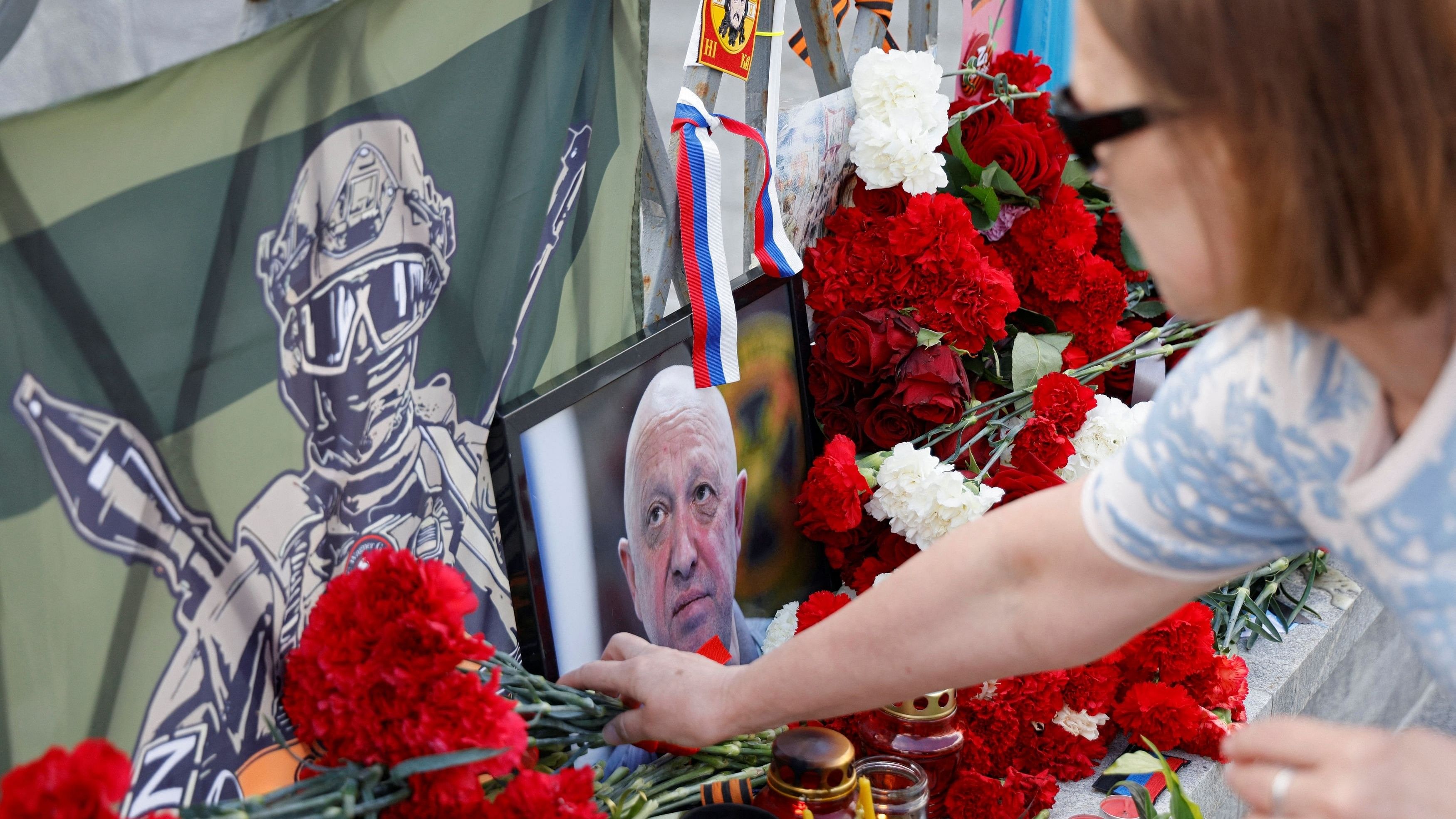 <div class="paragraphs"><p>A woman lays flowers at a makeshift memorial set up after the presumed death of Yevgeny Prigozhin, head of the Wagner mercenary group, in a plane crash, in Moscow, Russia August 25, 2023. </p></div>