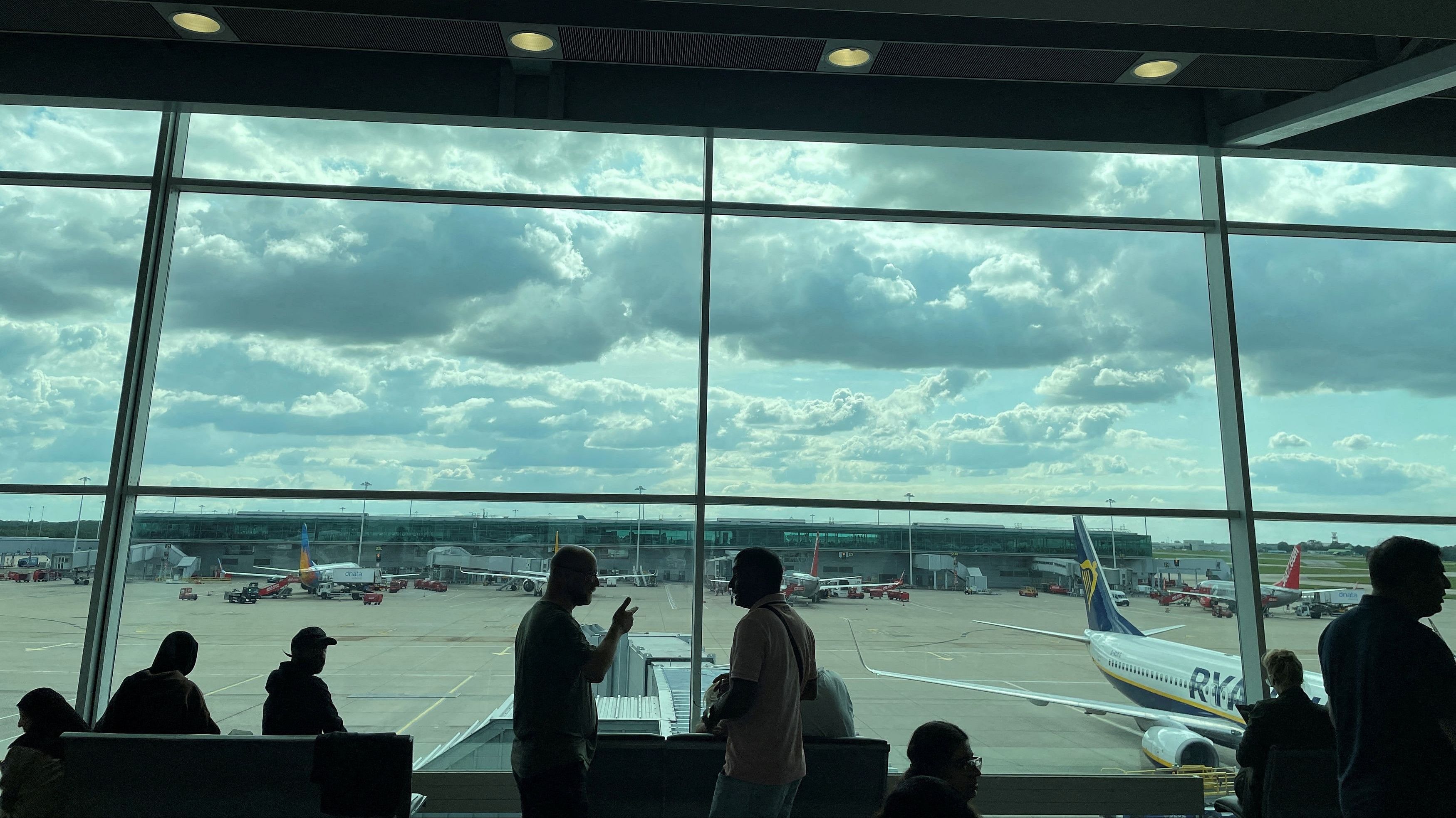 <div class="paragraphs"><p>Passengers awaiting news on cancelled or delayed flights at London Stansted Airport gesture as they discuss the situation on Monday, in Stansted, Britain.&nbsp;</p></div>