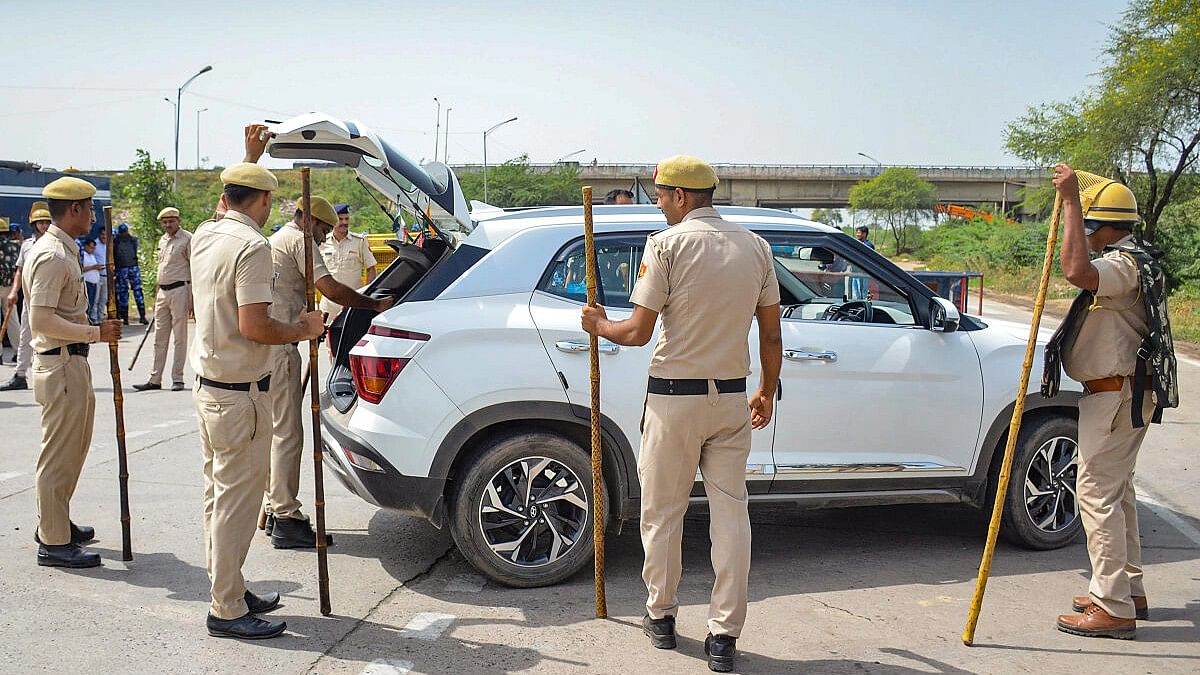 <div class="paragraphs"><p>Police personnel check a vehicle at Gurugram- Nuh border in Nuh district.&nbsp;</p></div>