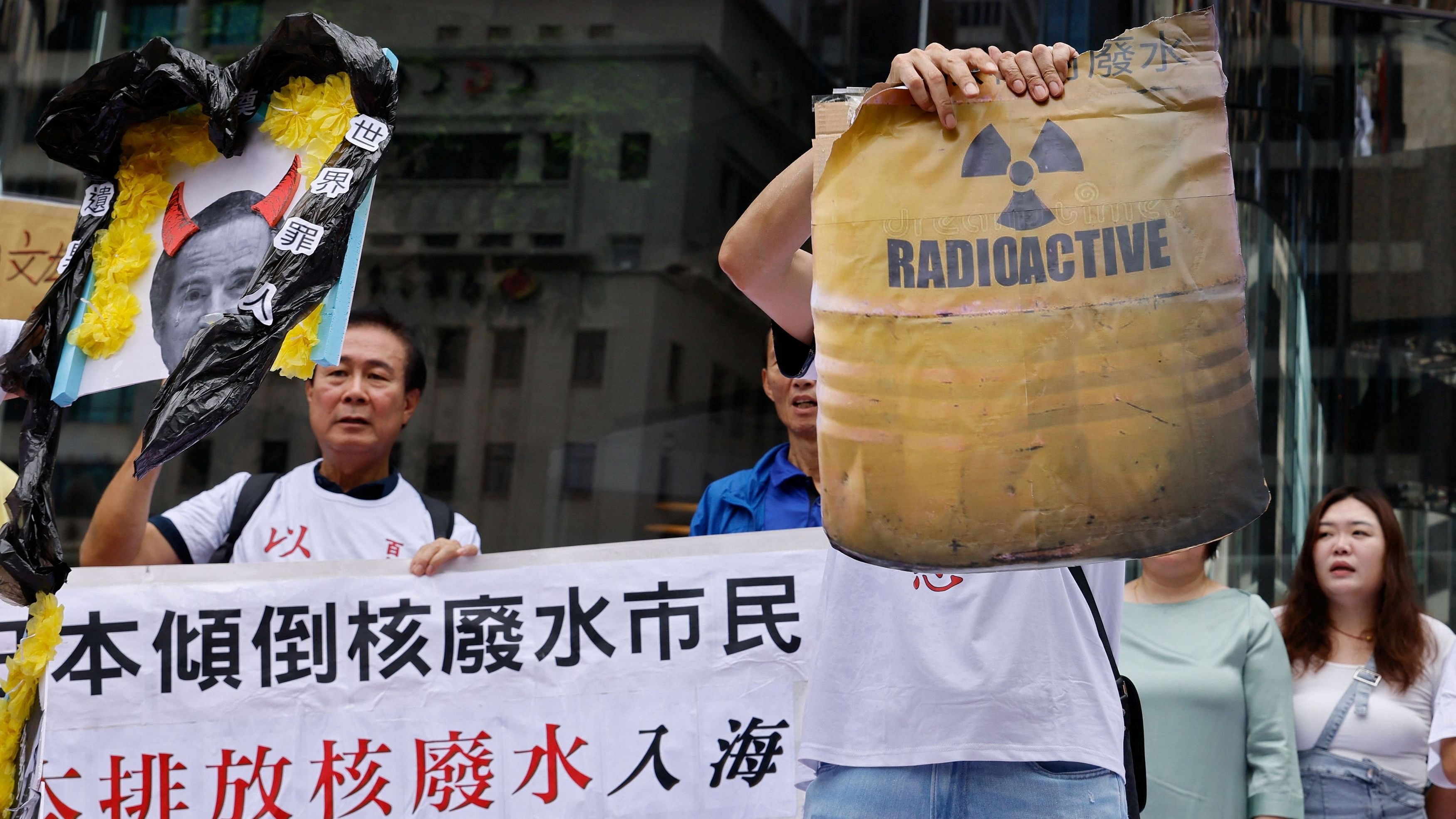 <div class="paragraphs"><p>A demonstrator tears off a cardboard with an image of a radioactive barrel during a protest after Japan's announcement to release treated radioactive water from the crippled Fukushima nuclear plant into the sea, in Hong Kong, China, August 24, 2023.</p></div>