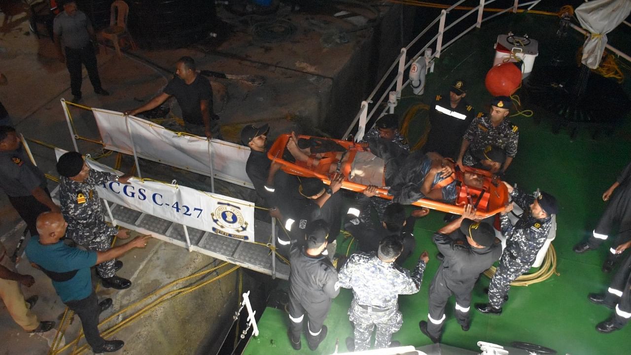 <div class="paragraphs"><p>Coast Guard personnel carrying out evacuation of the Filipine national.</p></div>