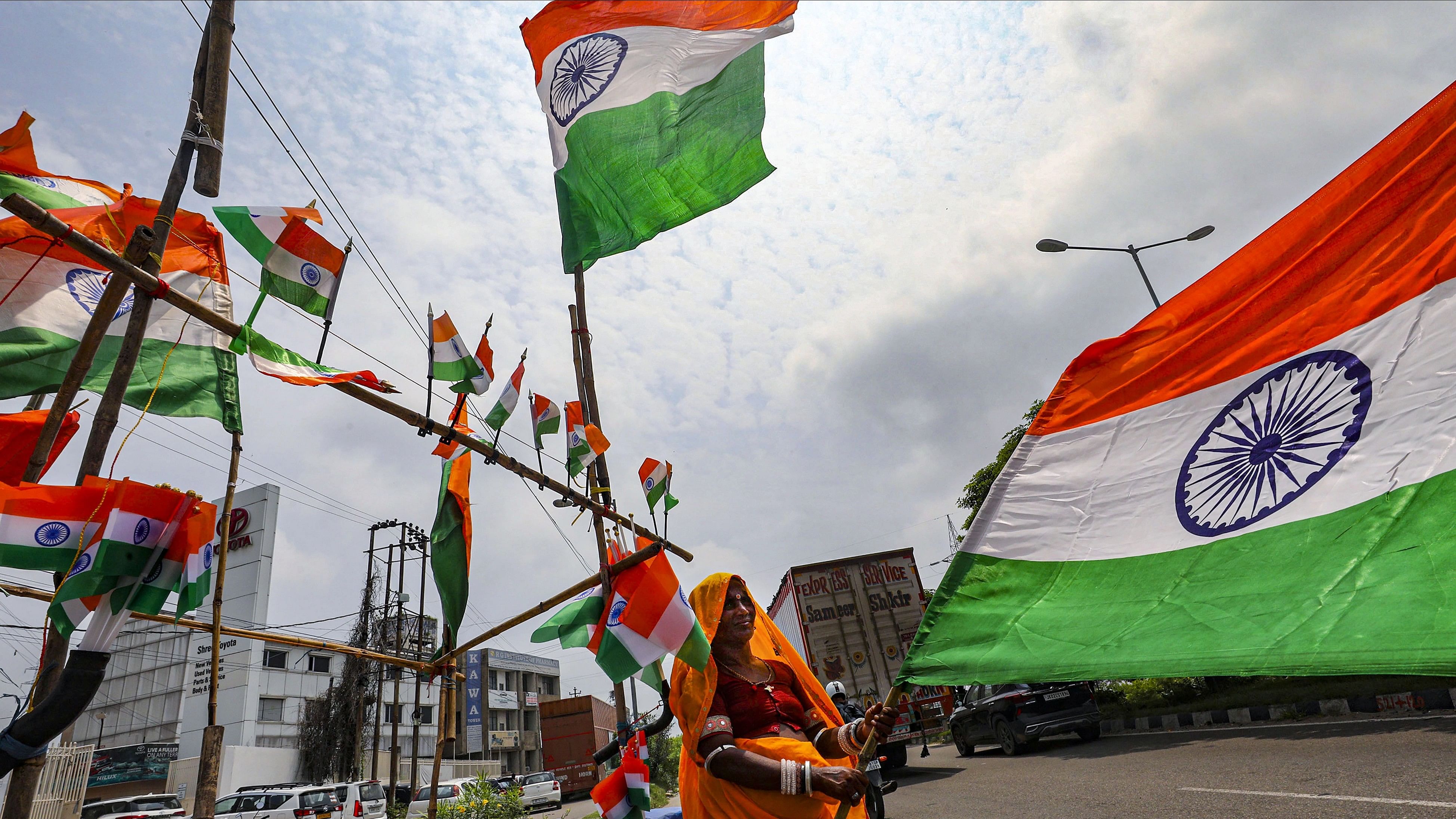 <div class="paragraphs"><p>A woman sells Indian tricolour flags ahead of the Independence Day celebration.</p></div>