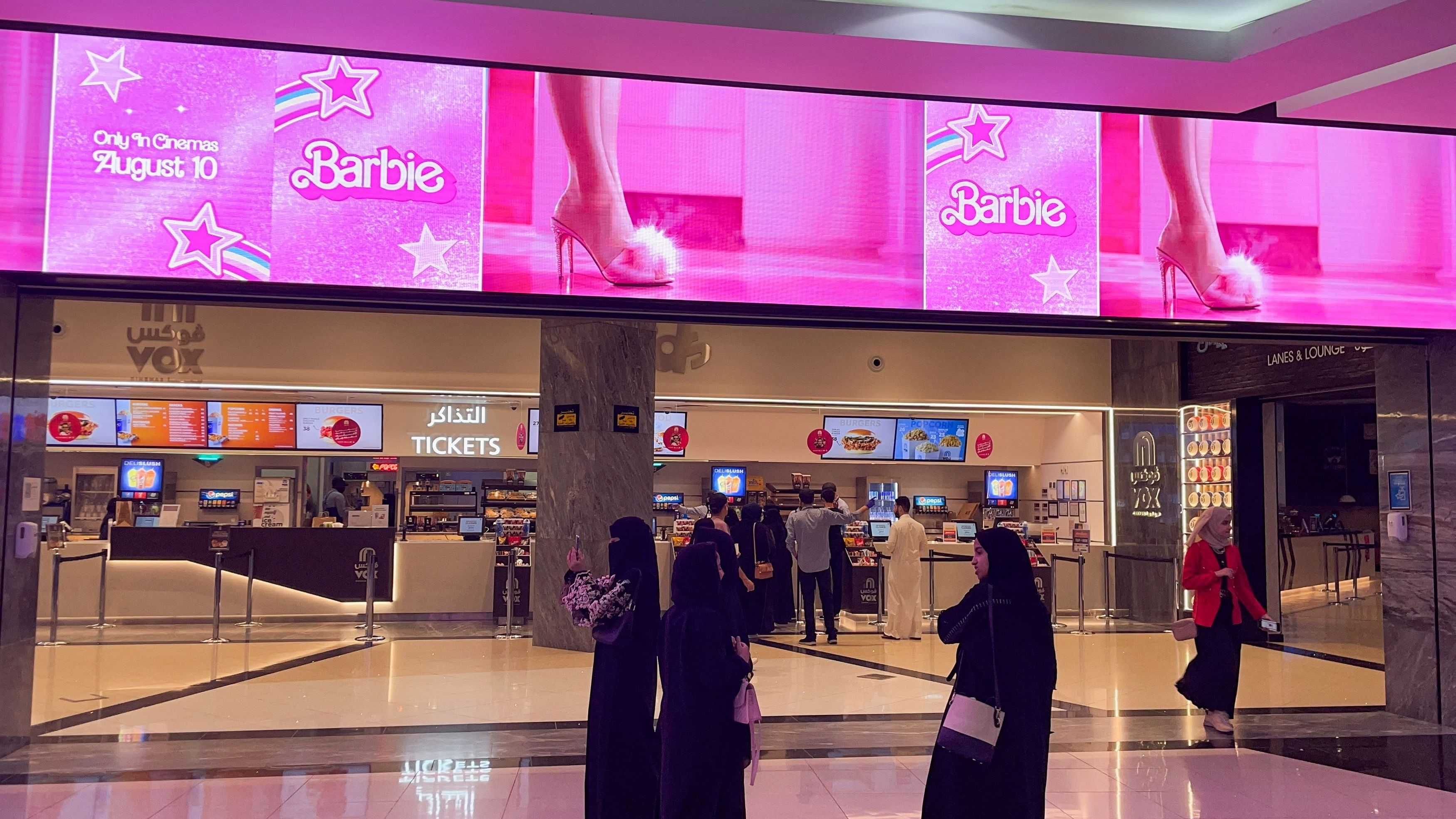 <div class="paragraphs"><p>Women stand as "Barbie" movie adverts are seen during the film's first screening at VOX Cinemas, in Riyadh, Saudi Arabia, August 10, 2023.</p></div>