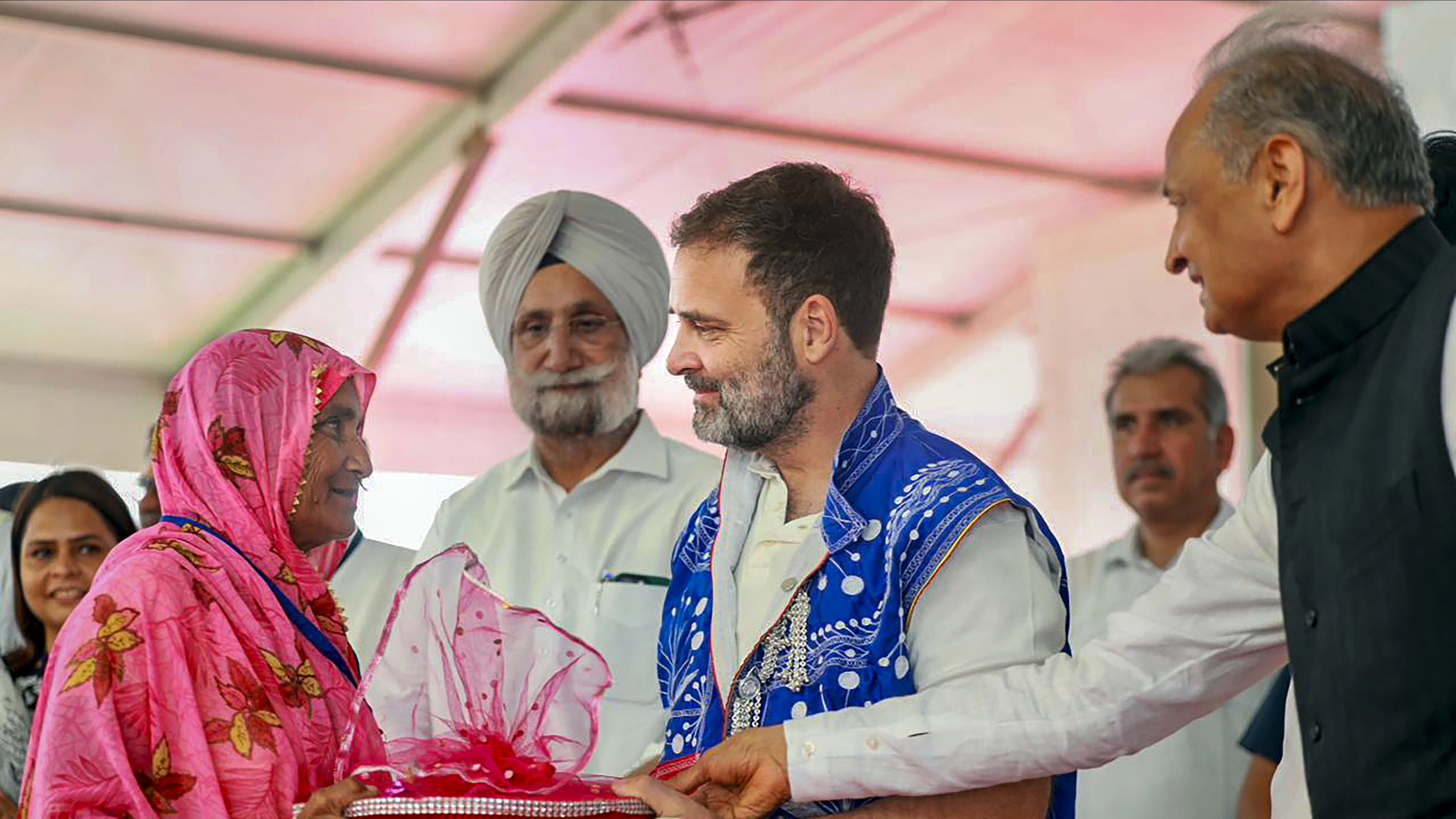 <div class="paragraphs"><p>Congress leader Rahul Gandhi with Rajasthan Chief Minister Ashok Gehlot and AICC in-charge of Rajasthan Sukhjinder Singh Randhawa during a public meeting at Mangarh Dham, in Banswara, Wednesday, August 9, 2023. </p></div>