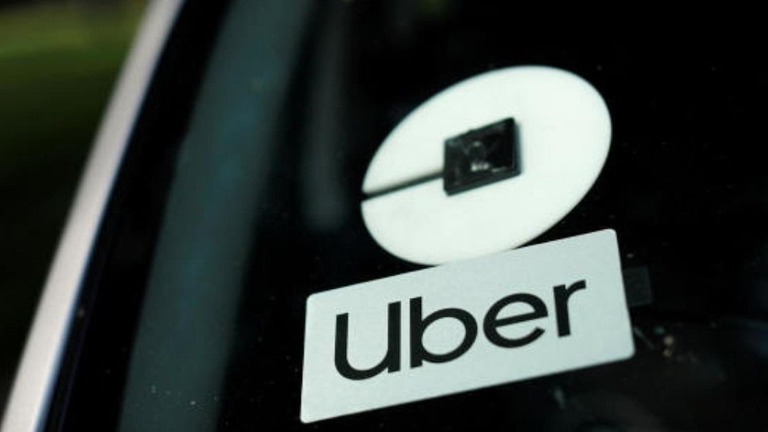 <div class="paragraphs"><p>An Uber logo is shown on a rideshare vehicle. </p></div>