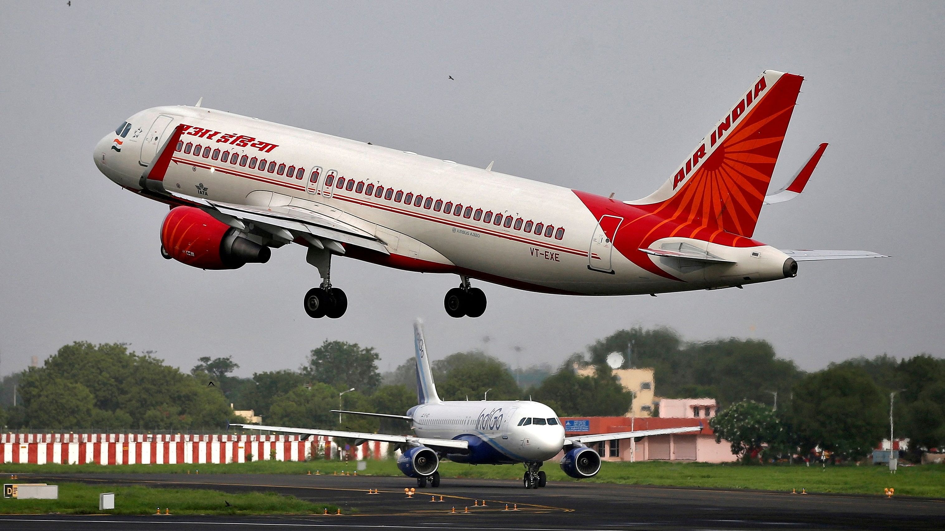 <div class="paragraphs"><p>An Air India Airbus A320-200 aircraft takes off as an IndiGo Airlines aircraft waits for clearance at Sardar Vallabhbhai Patel International Airport in Ahmedabad.</p></div>