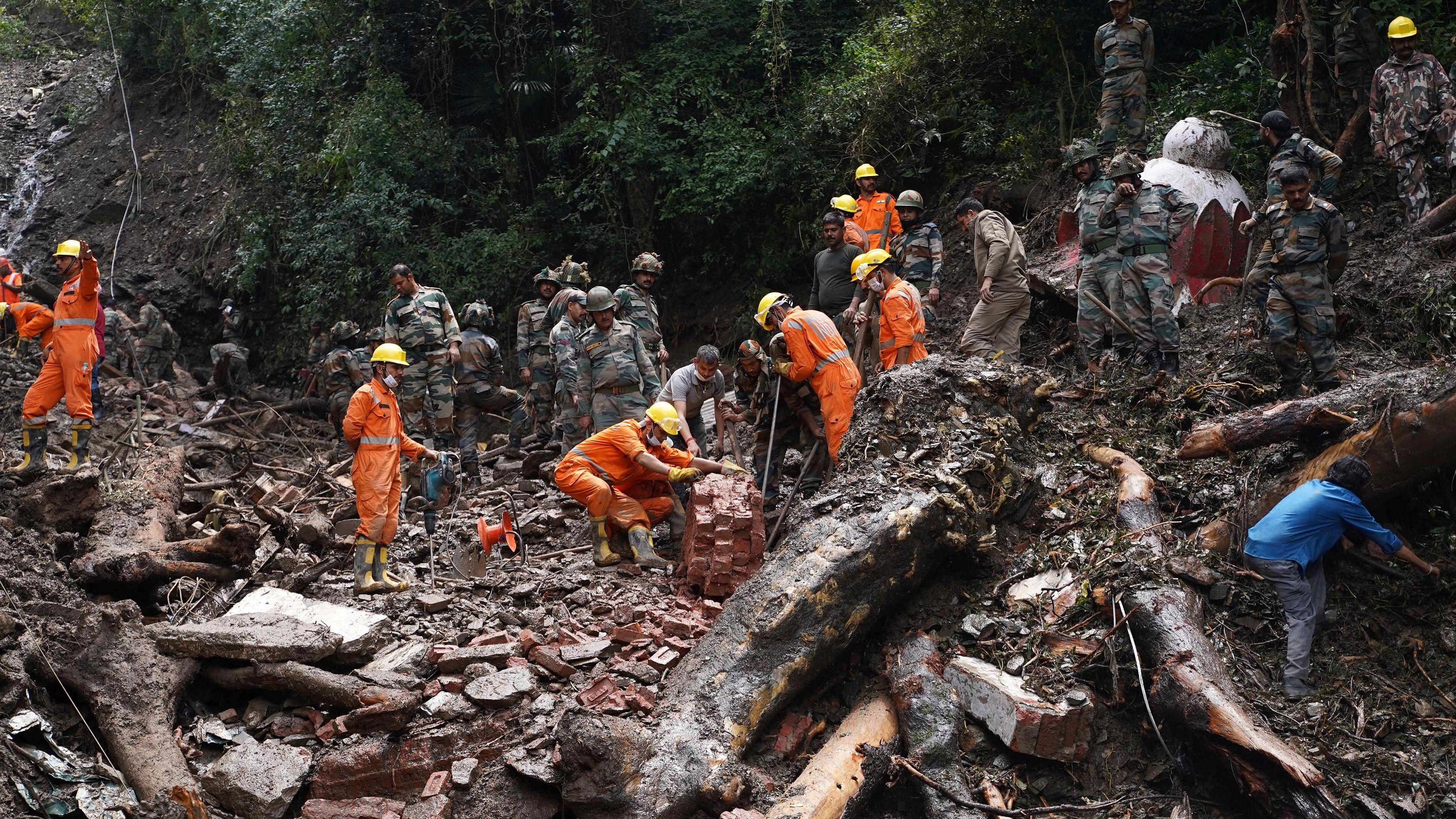 <div class="paragraphs"><p>Rescue workers remove the debris as a search operation continues in the aftermath of a landslide following torrential rain in Shimla.</p></div>