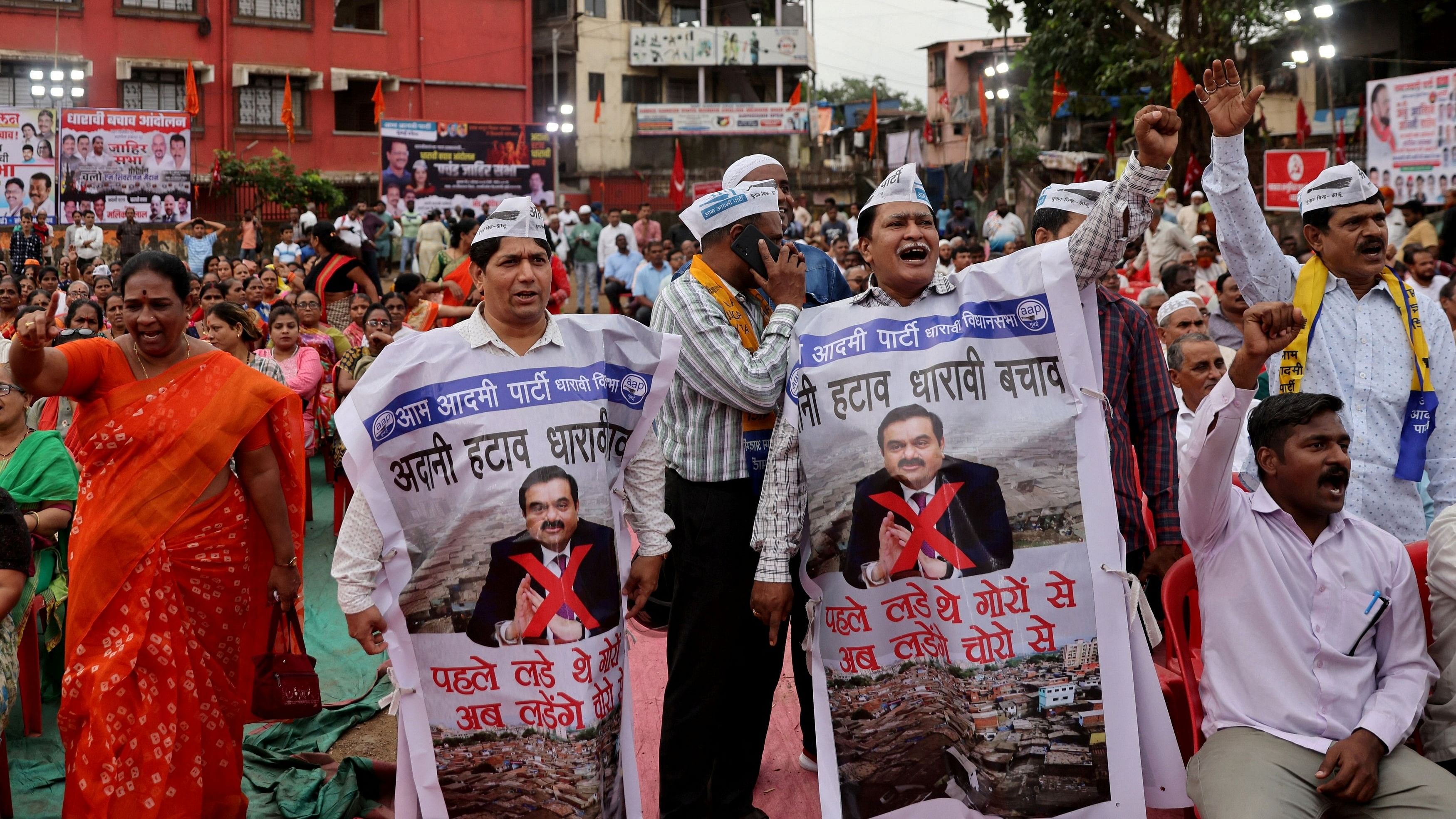 <div class="paragraphs"><p>People shout slogans as they wear banners during a protest against the redevelopment of Dharavi, one of Asia's largest slums, by the Adani Group in Mumbai, India, August 9, 2023. Banners read: "Remove Adani, Save Dharavi" and "First we fought the whites now we fight the thieves". </p></div>