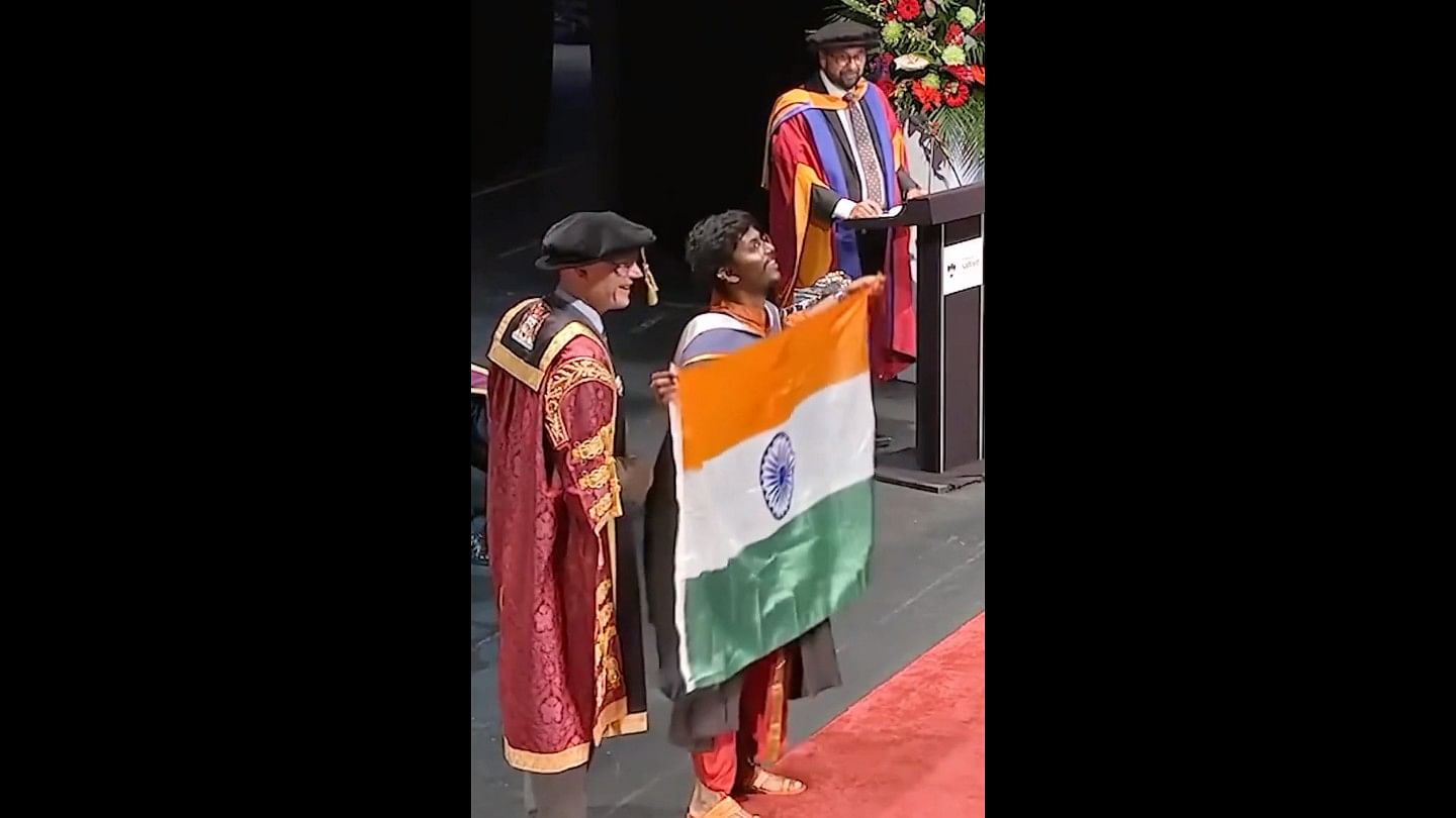 <div class="paragraphs"><p>Screengrab of the video showing the student unfurl the Indian flag at a graduation ceremony abroad.</p></div>