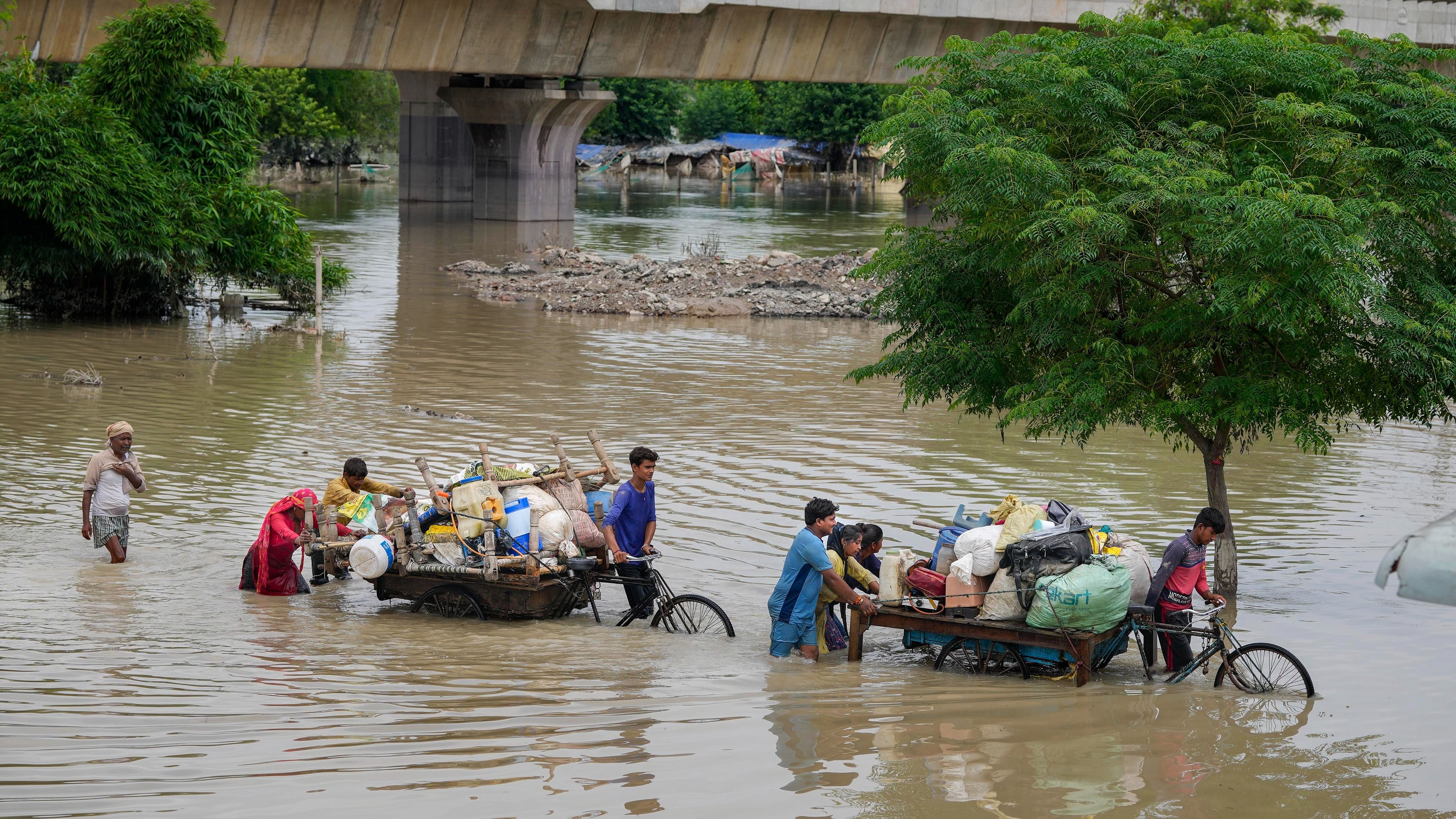 <div class="paragraphs"><p>People from low-lying areas carry their belongings while relocating to a safer place after the Yamuna River inundated the nearby areas following recent heavy monsoon rains, in New Delhi.</p></div>