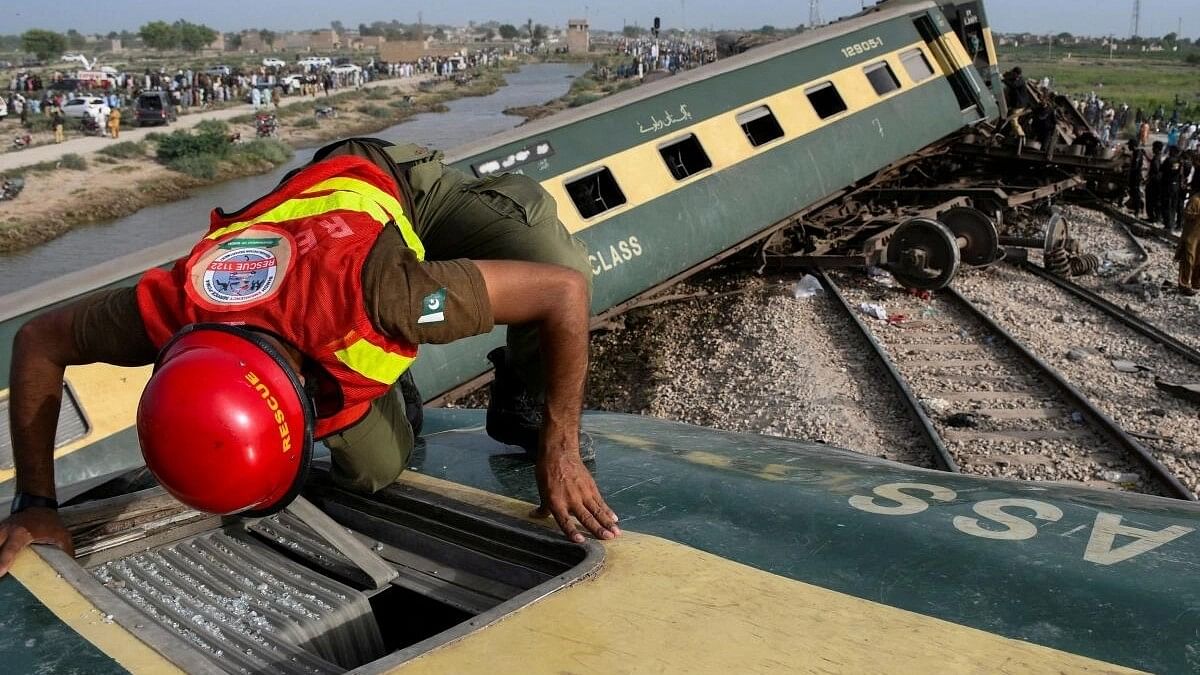 <div class="paragraphs"><p>A rescue worker searches for victims after a train derailed in Sarhari town in district Sanghar, Pakistan August 6, 2023.</p></div>