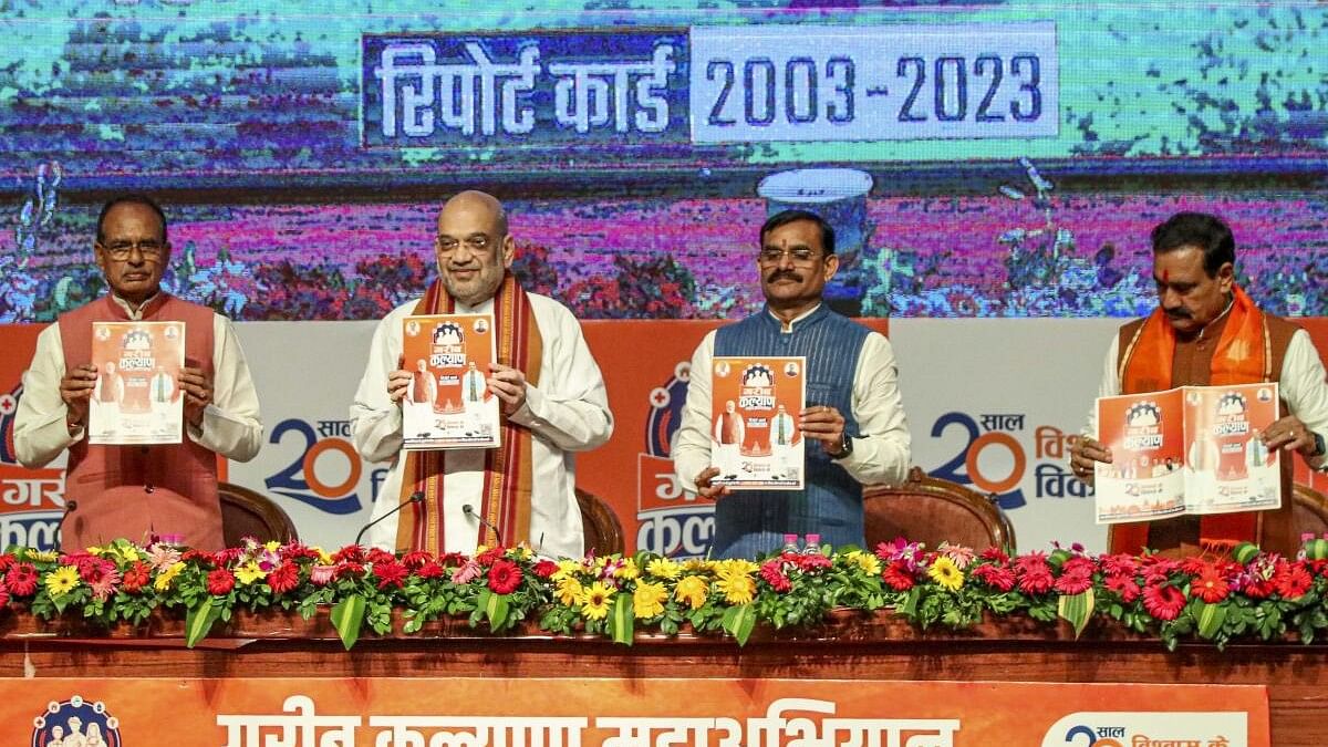 <div class="paragraphs"><p>Union Home Minister Amit Shah with Madhya Pradesh Chief Minister Shivraj Singh Chouhan during the launch of the 'Garib Kalyan Maha Abhiyan' along with the report card of the 20 years of the BJP government in the state, in Bhopal.</p></div>