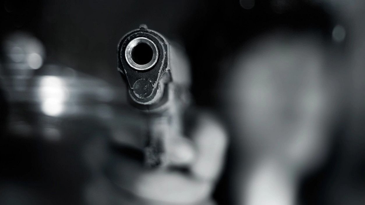 <div class="paragraphs"><p>A representative image of a person holding a gun.</p></div>