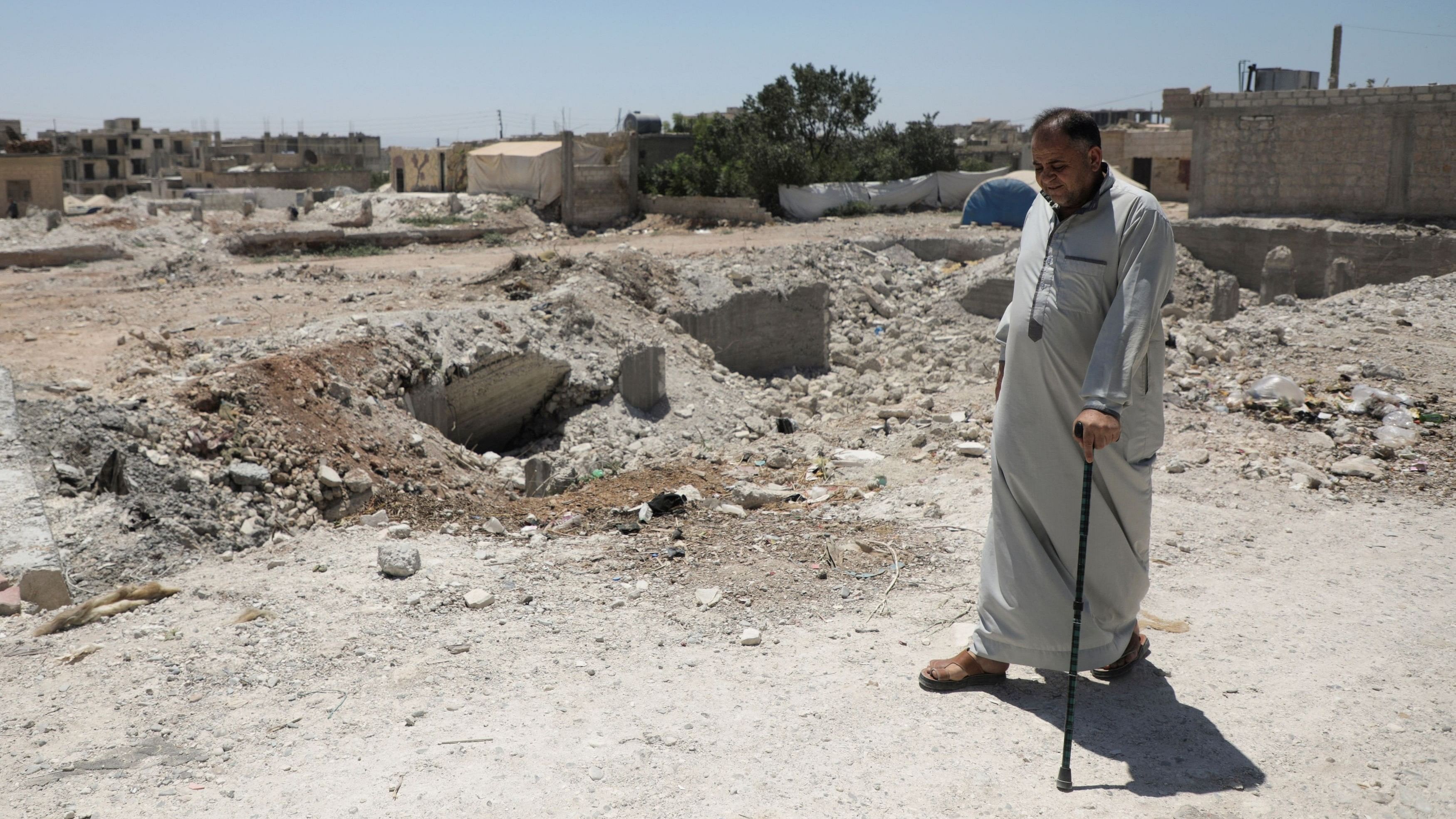 <div class="paragraphs"><p>Syrian quake survivor, Habib Gharib Habib, walks past rubble of damaged buildings in Jandaris, almost six months after a devastating earthquake, in northern Syria.</p></div>