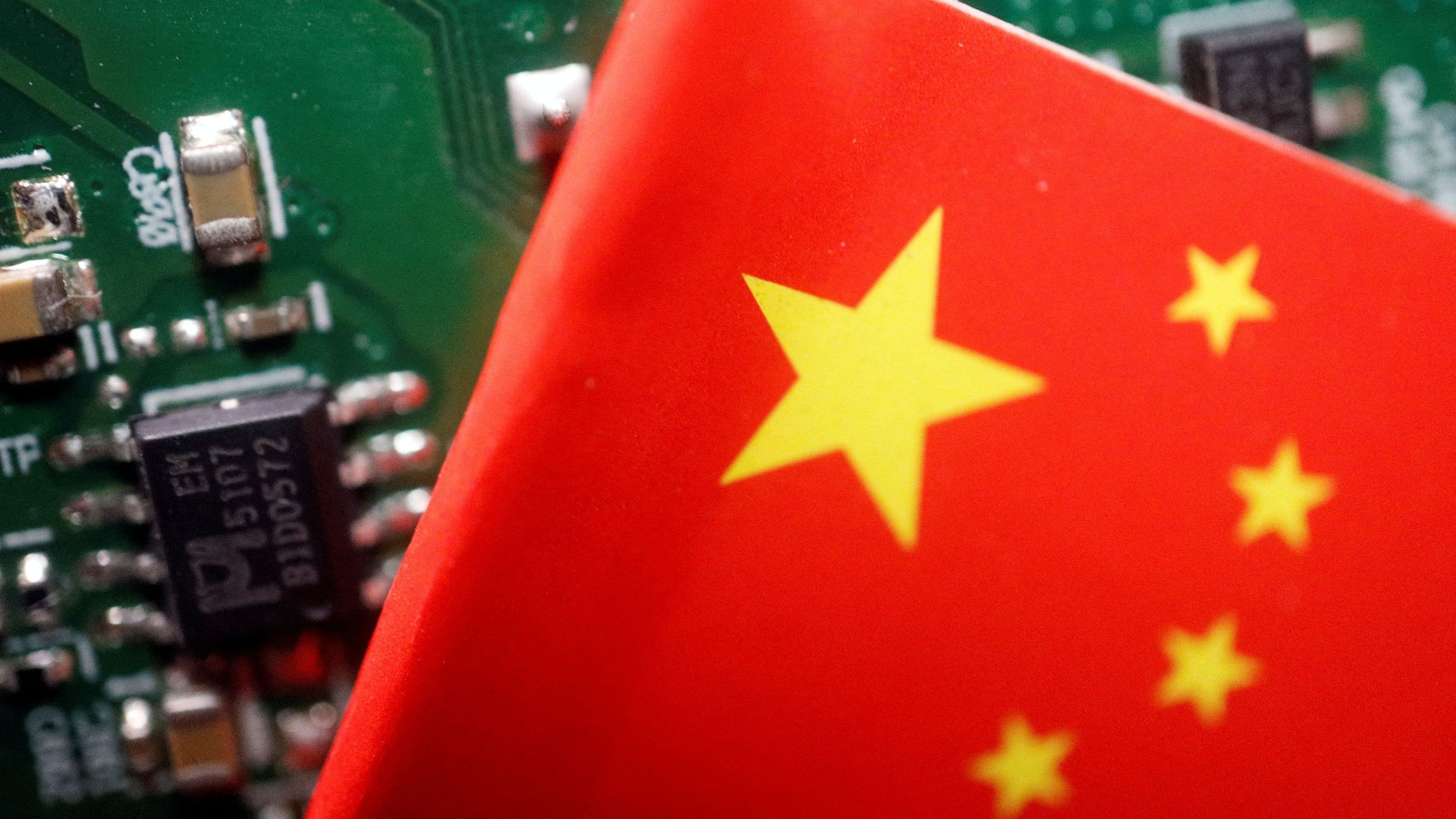 <div class="paragraphs"><p>FILE PHOTO: A Chinese flag is displayed next to a "Made in China" sign seen on a printed circuit board with semiconductor chips.</p></div>