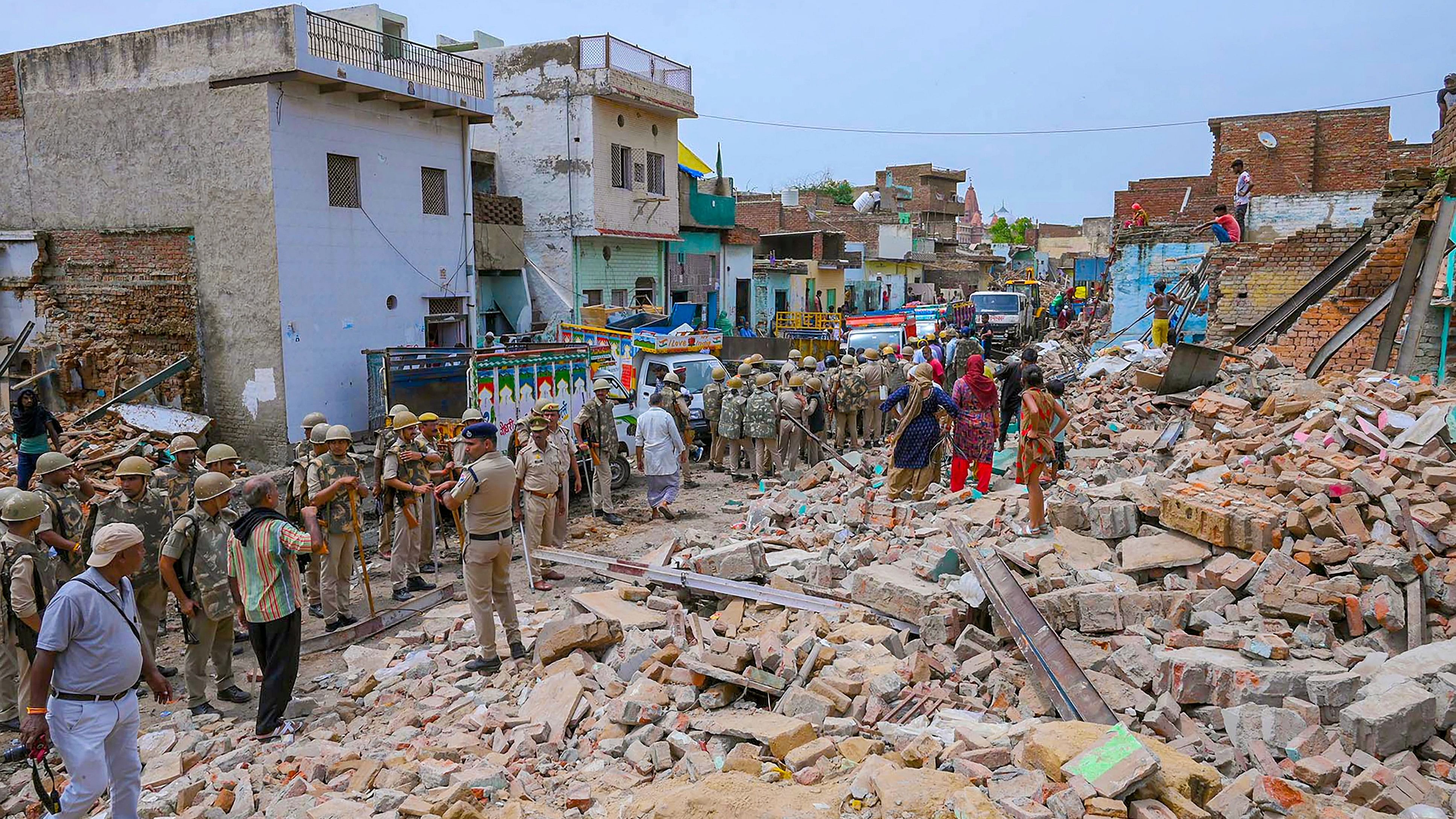 <div class="paragraphs"><p> Security personnel stand guard during removal of encroachments from railway land along the Mathura-Vrindavan railway line, in Mathura.</p></div>