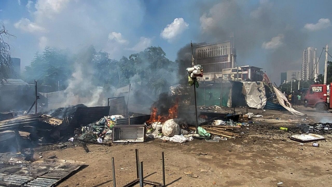 <div class="paragraphs"><p>Flames and smoke rise from shops and other temporary structures, set ablaze by miscreants in a fresh case of communal violence after Monday's attack on a VHP procession in adjoining Nuh district, at Badshahpur area in Gurugram, Tuesday, Aug. 1, 2023. </p></div>