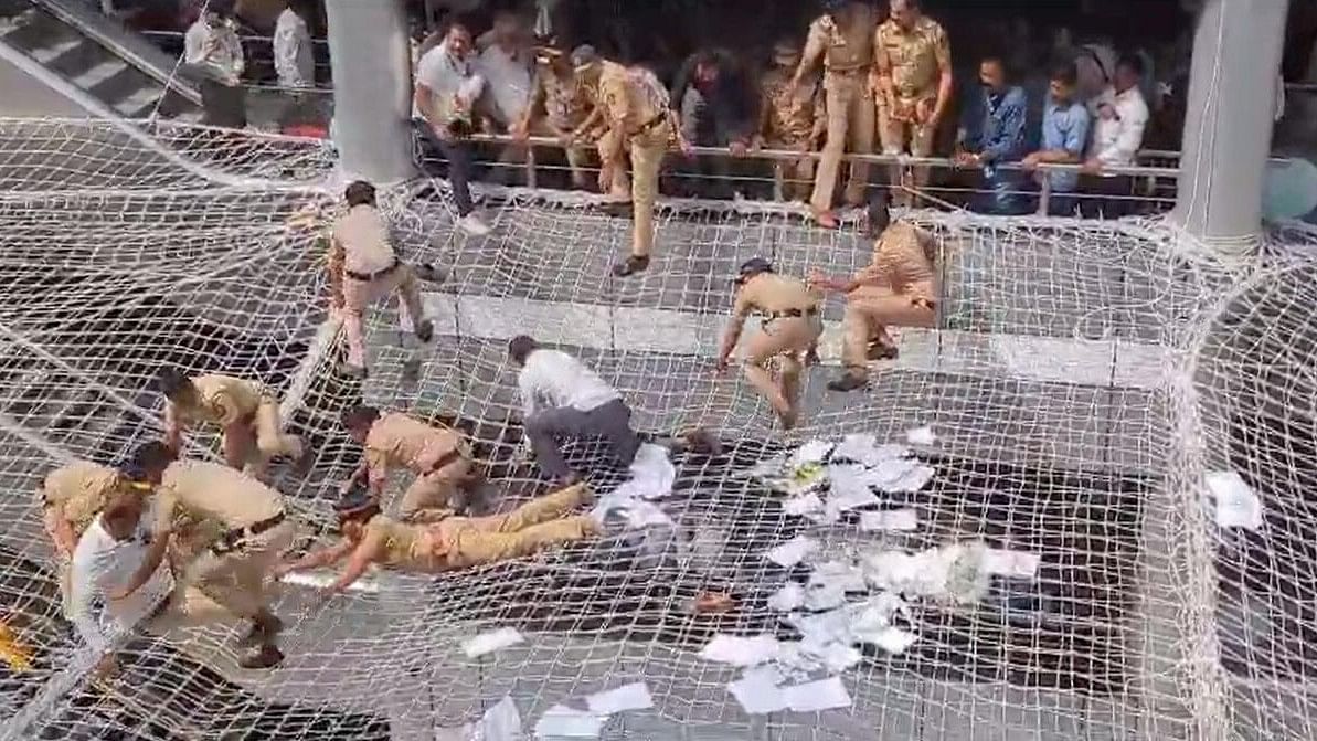 <div class="paragraphs"><p>Police personnel pull back the farmers who jumped on the safety nets during a protest against low compensation for their land in the Mantralaya building, in Mumbai.</p></div>