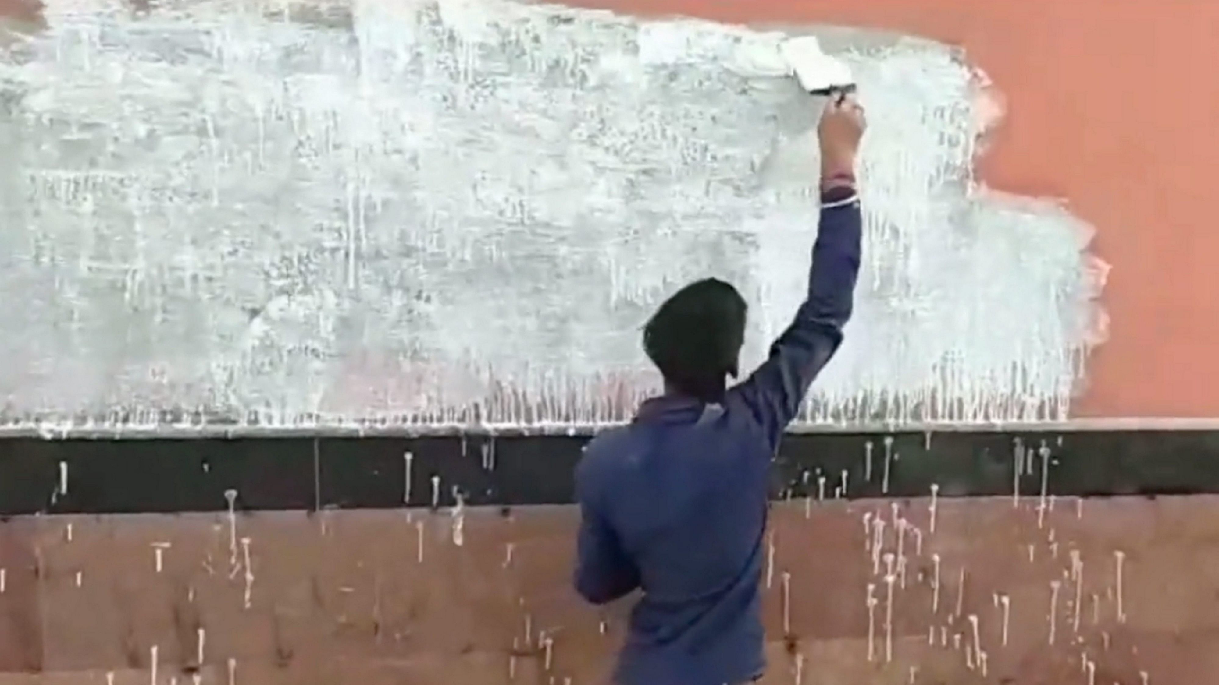 <div class="paragraphs"><p>A worker paints a wall on which pro-Khalistan slogans were written at Shivaji Park metro station, in New Delhi.</p></div>