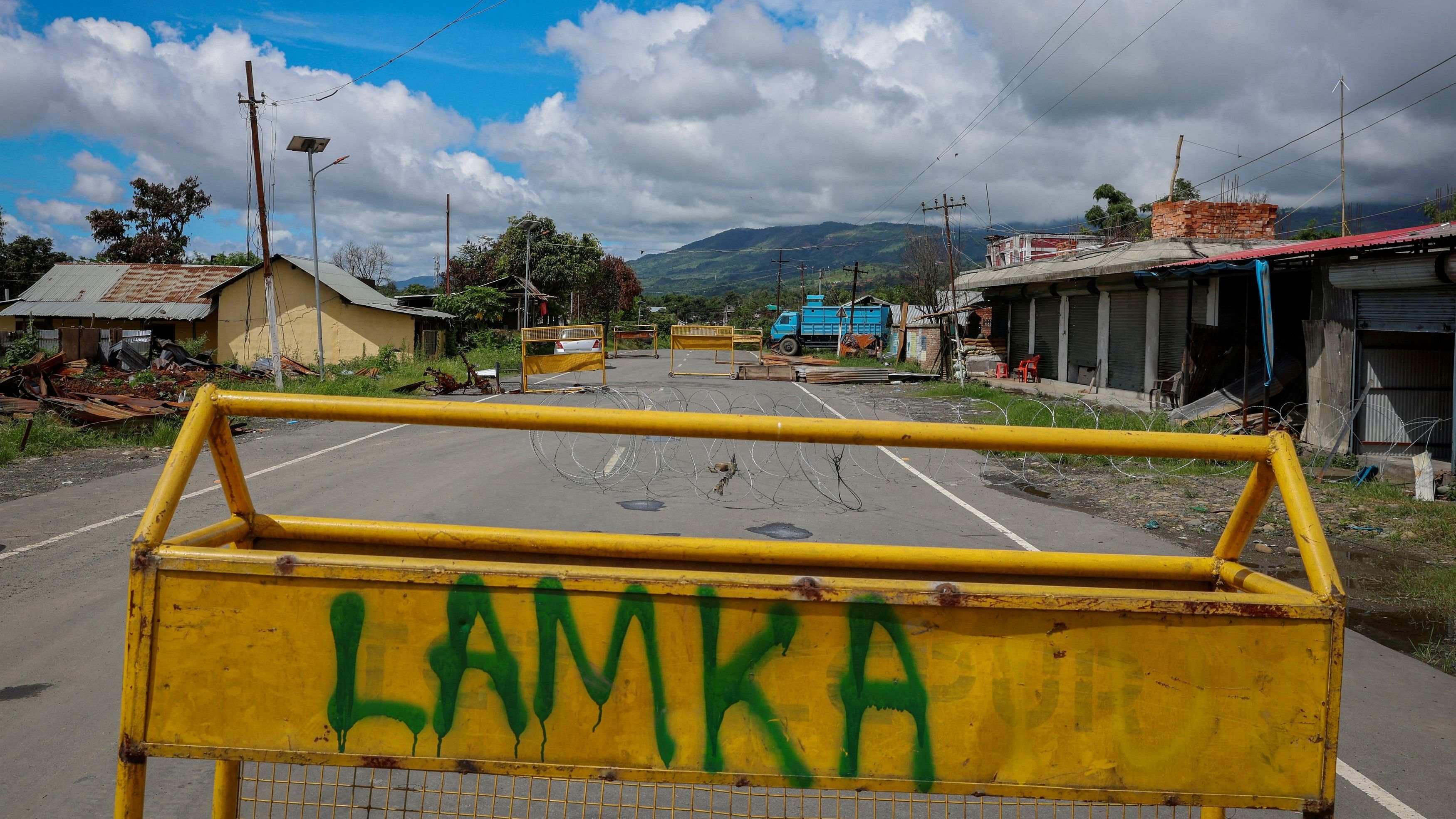 <div class="paragraphs"><p>Police barricades are pictured on a deserted road at Torbung village in Churachandpur district in Manipur.</p></div>