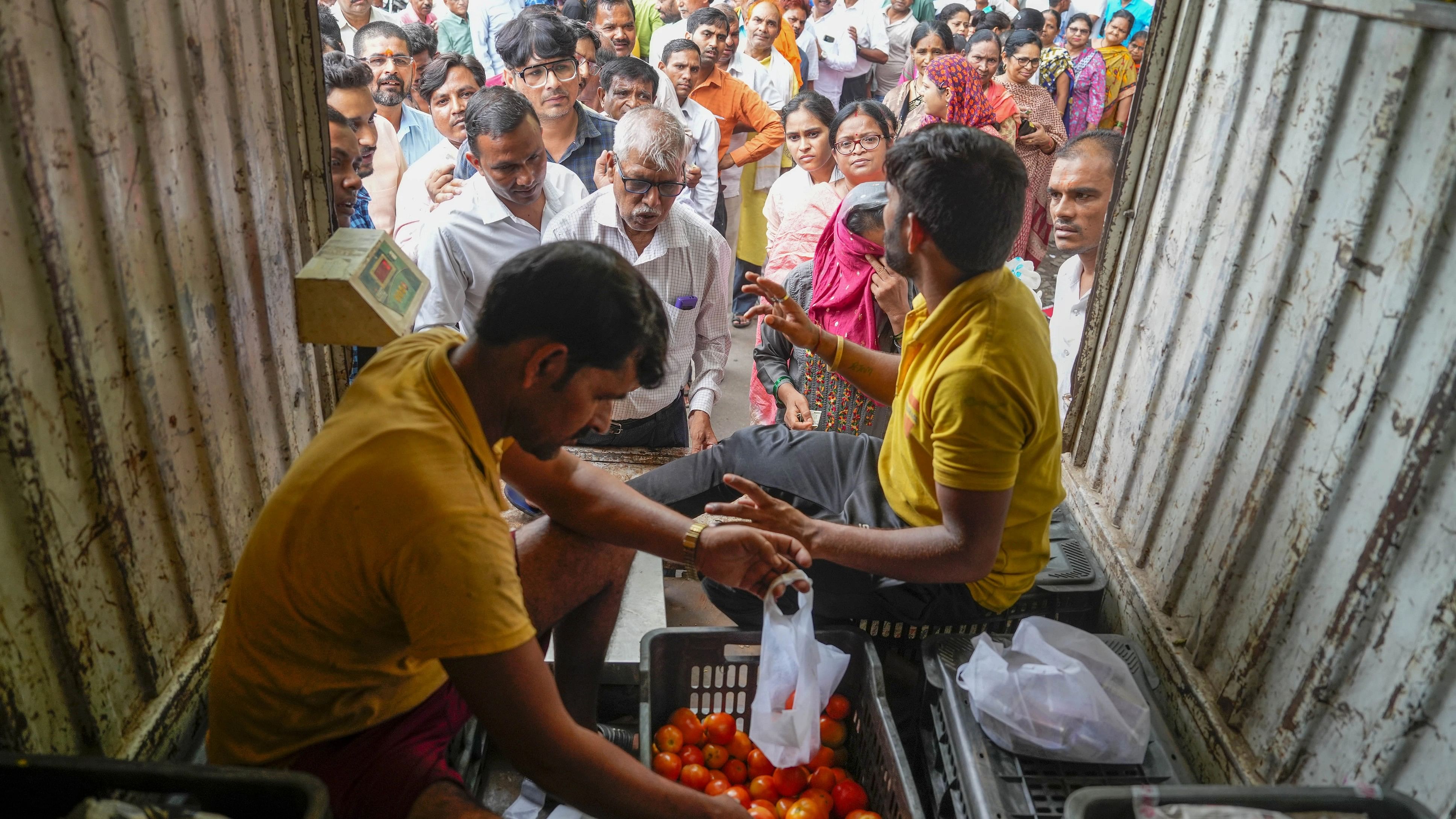 <div class="paragraphs"><p>People buy tomatoes at a discounted rate from a mobile van of National Cooperative Consumers' Federation of India.&nbsp; </p></div>