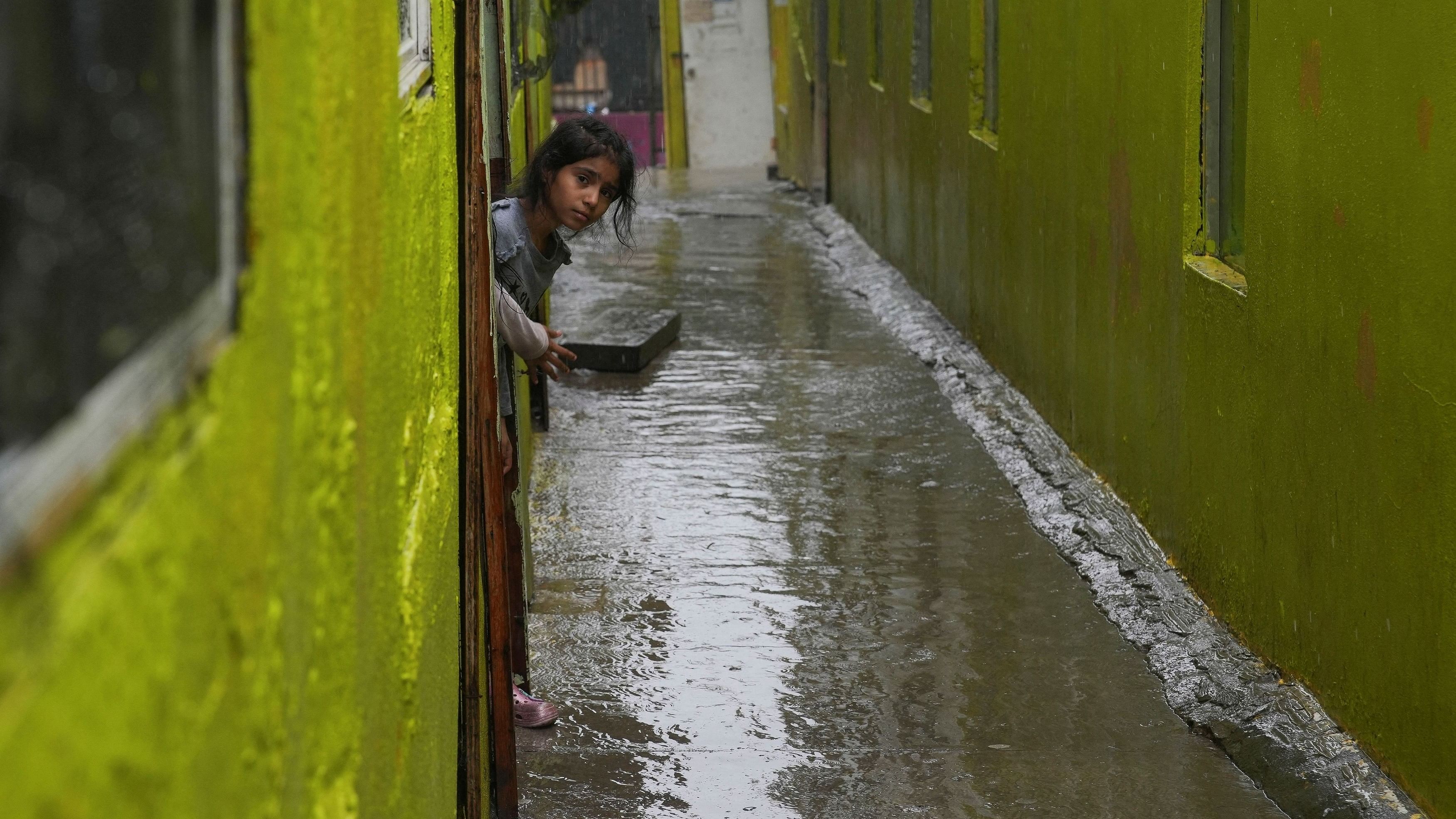 <div class="paragraphs"><p>A migrant girl looks at the wet corridor at Agape shelter as Tropical Storm Hilary hits Baja California state, in Tijuana, Mexico</p></div>