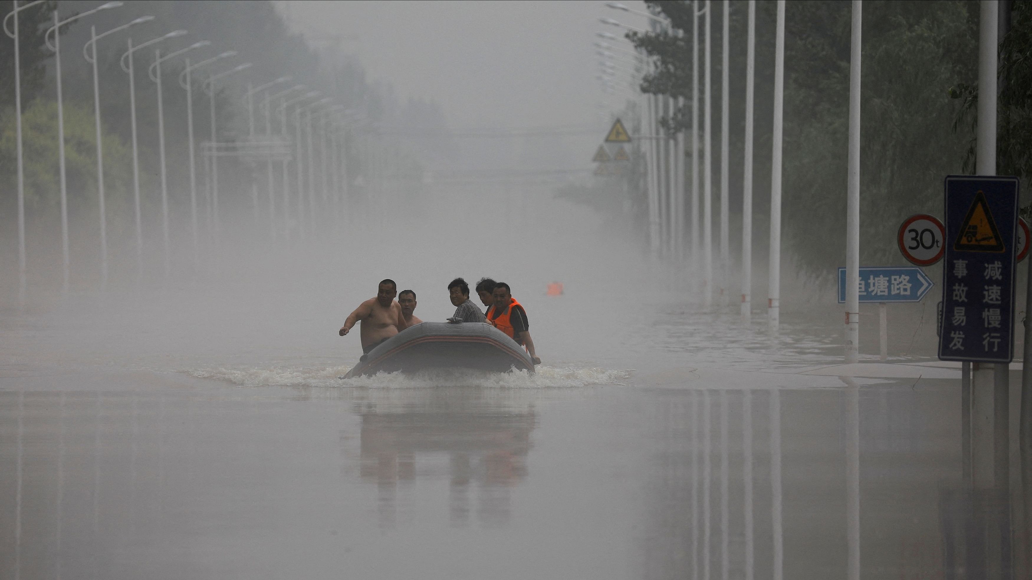 <div class="paragraphs"><p>FILE PHOTO: People ride a boat through a flooded road after the rains and floods brought by remnants of Typhoon Doksuri, in Zhuozhou, Hebei province, China August 3, 2023. </p></div>