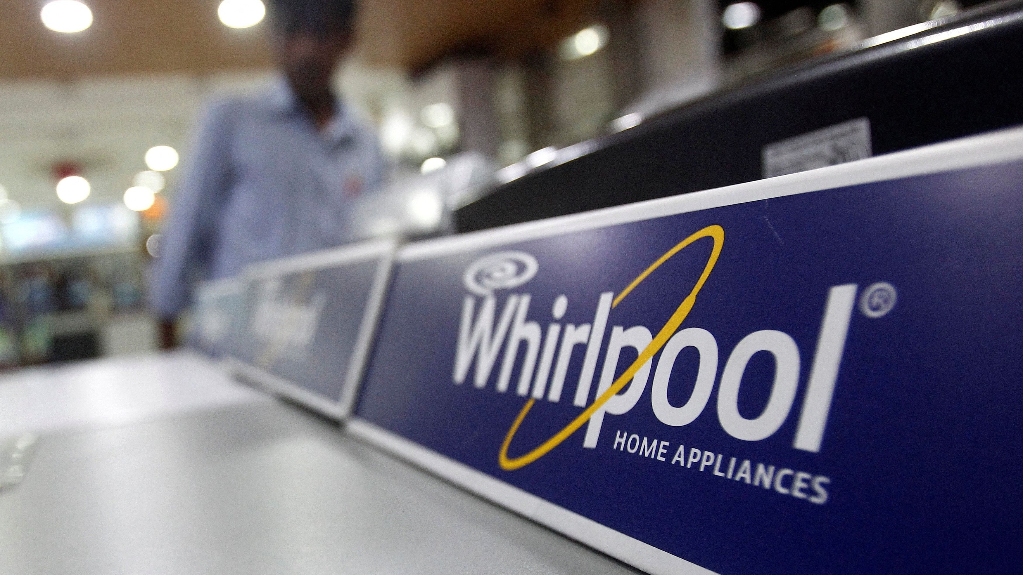 <div class="paragraphs"><p>An employee stands next to a Whirlpool washing machine inside a home appliances showroom.</p></div>