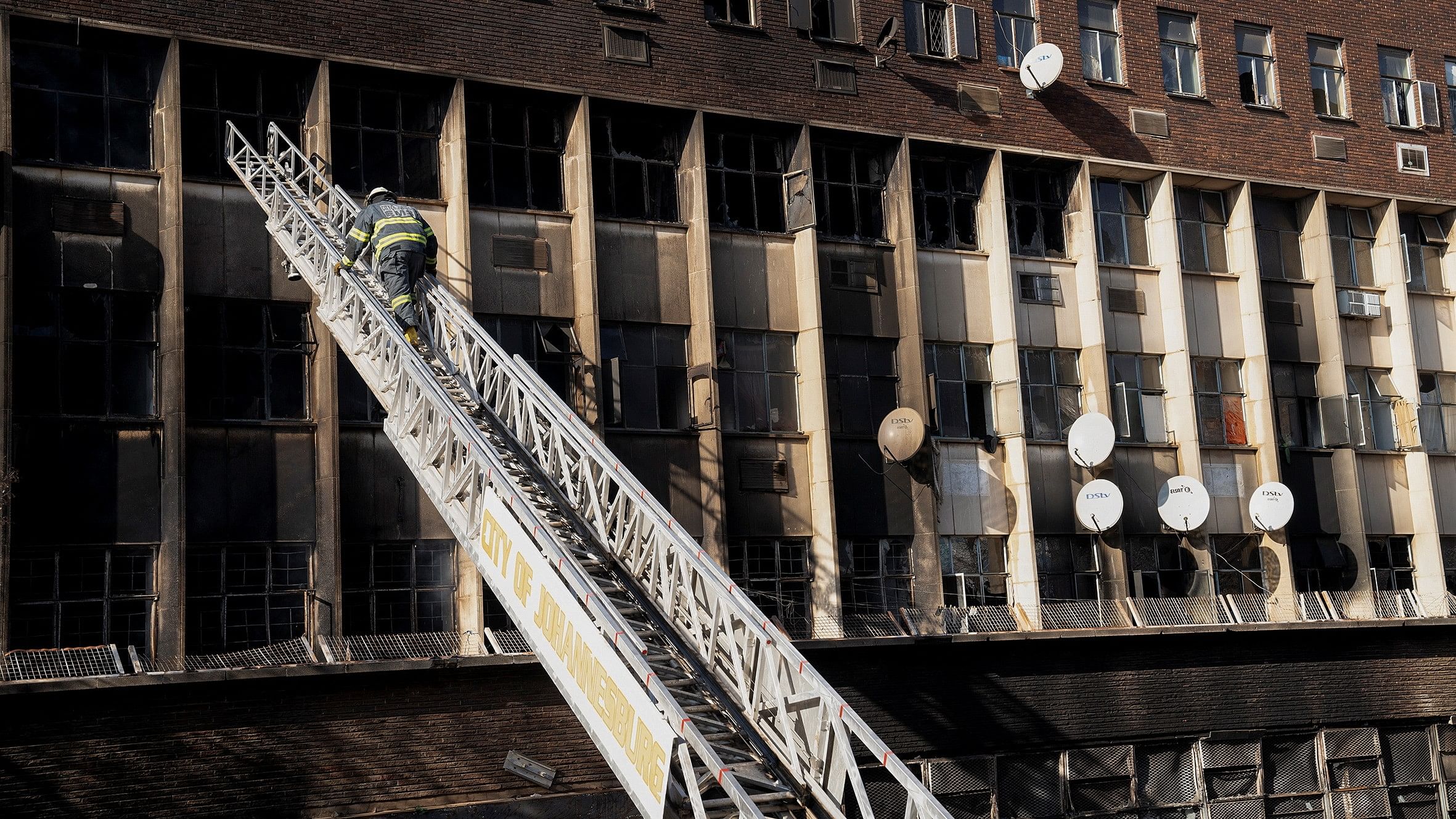 <div class="paragraphs"><p>A firefighter works at the scene of a deadly fire which occurred in the early hours of the morning in Johannesburg, South Africa.&nbsp;</p></div>