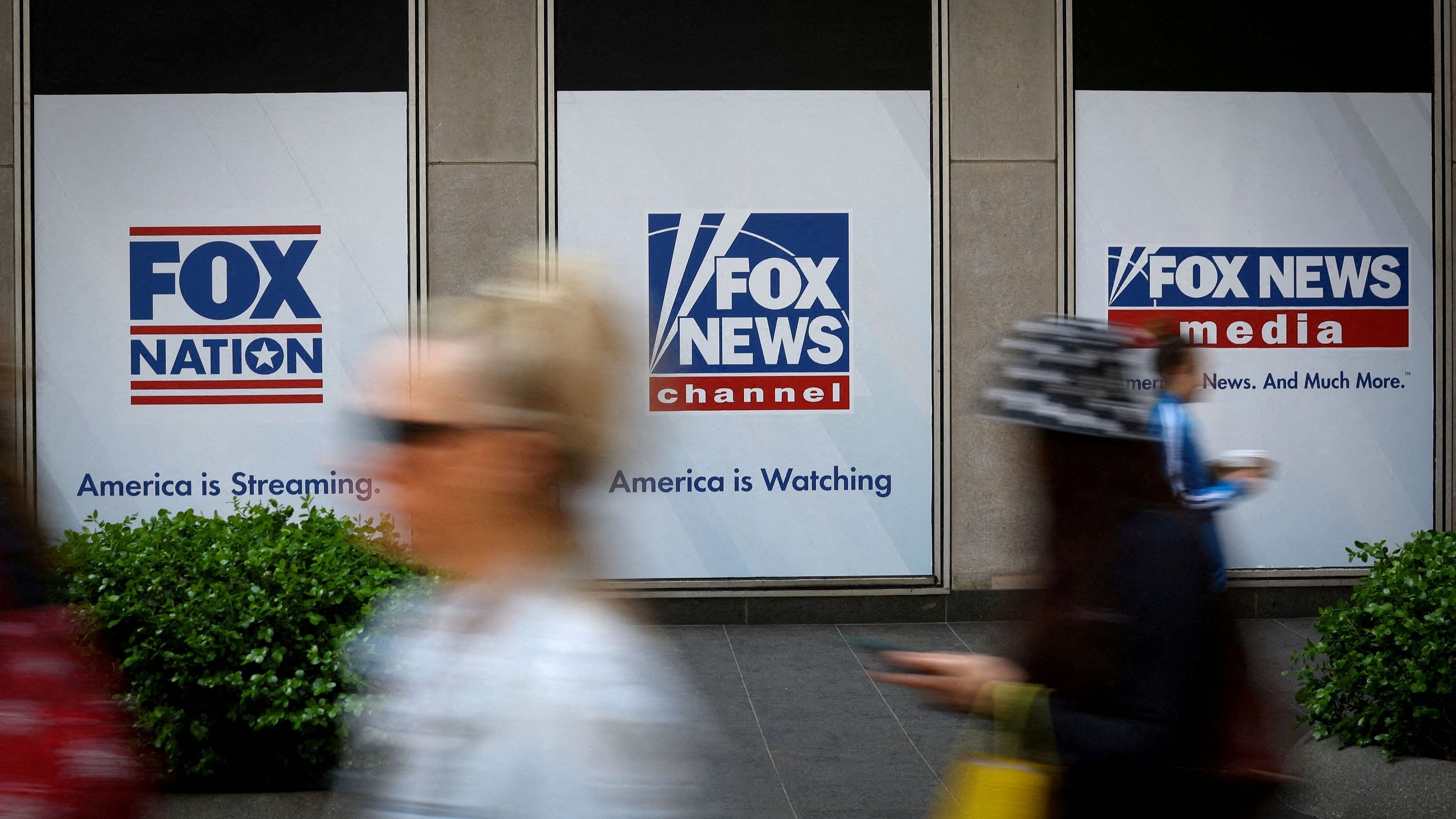 <div class="paragraphs"><p>People walk past Fox News posters on the exterior of the News Corporation and Fox News headquarters building in Manhattan in New York City.</p></div>
