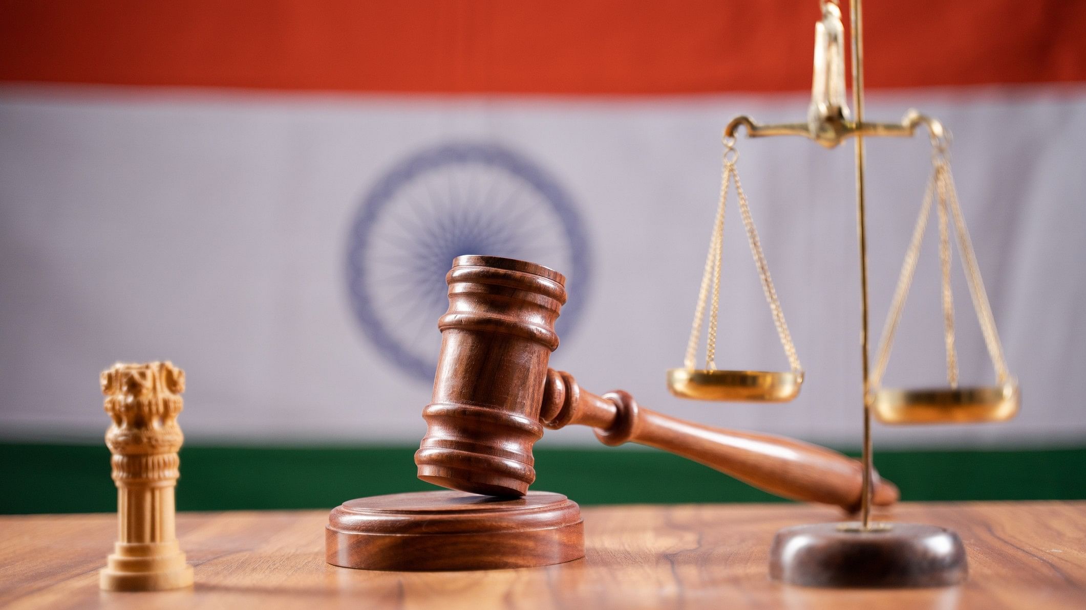 <div class="paragraphs"><p>Representative image showing gavel and scales against the backdrop of India's flag denoting the nation's legal system.</p></div>