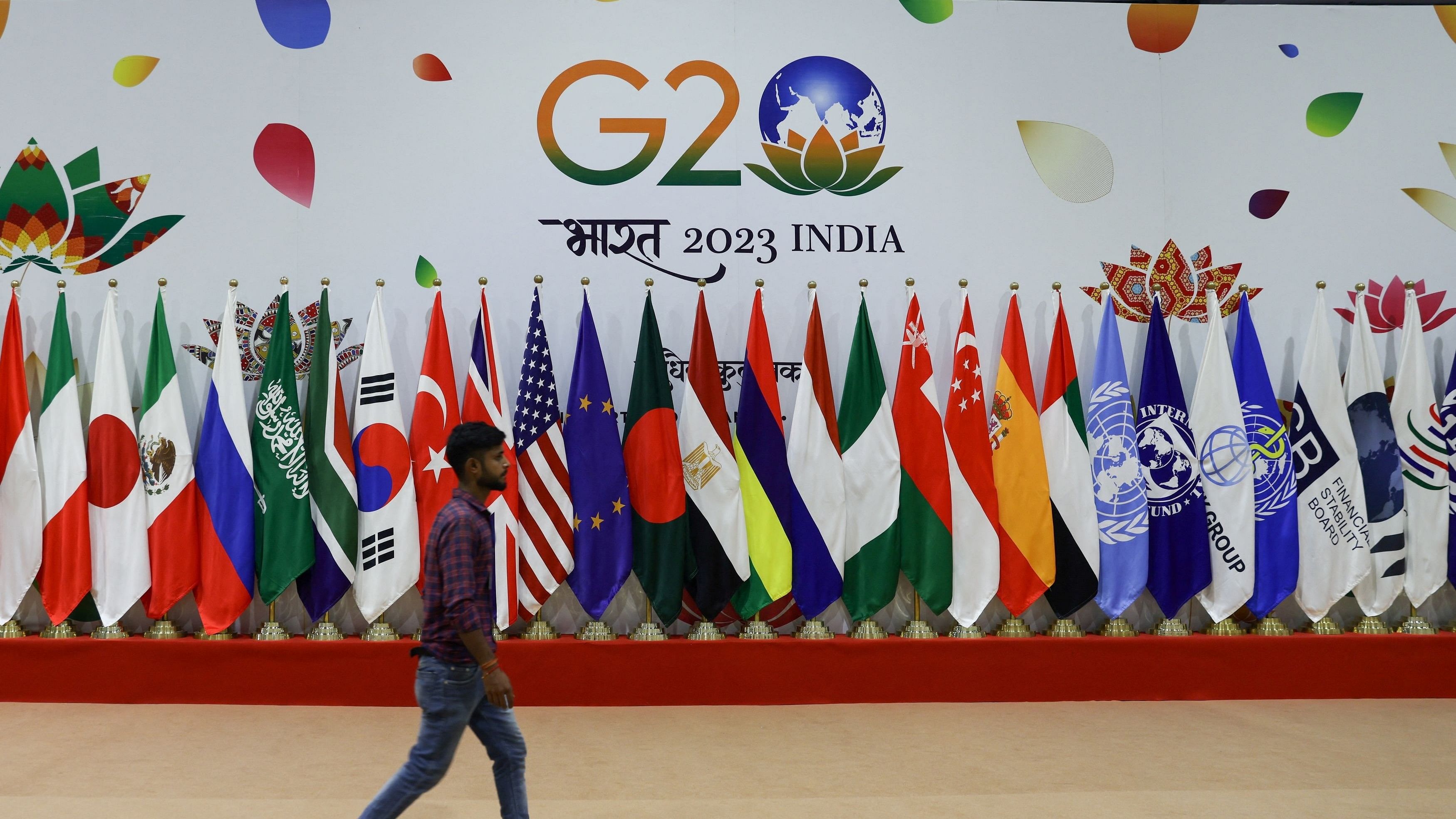 <div class="paragraphs"><p>A man walks near flags ahead of G20 Summit in New Delhi.</p></div>