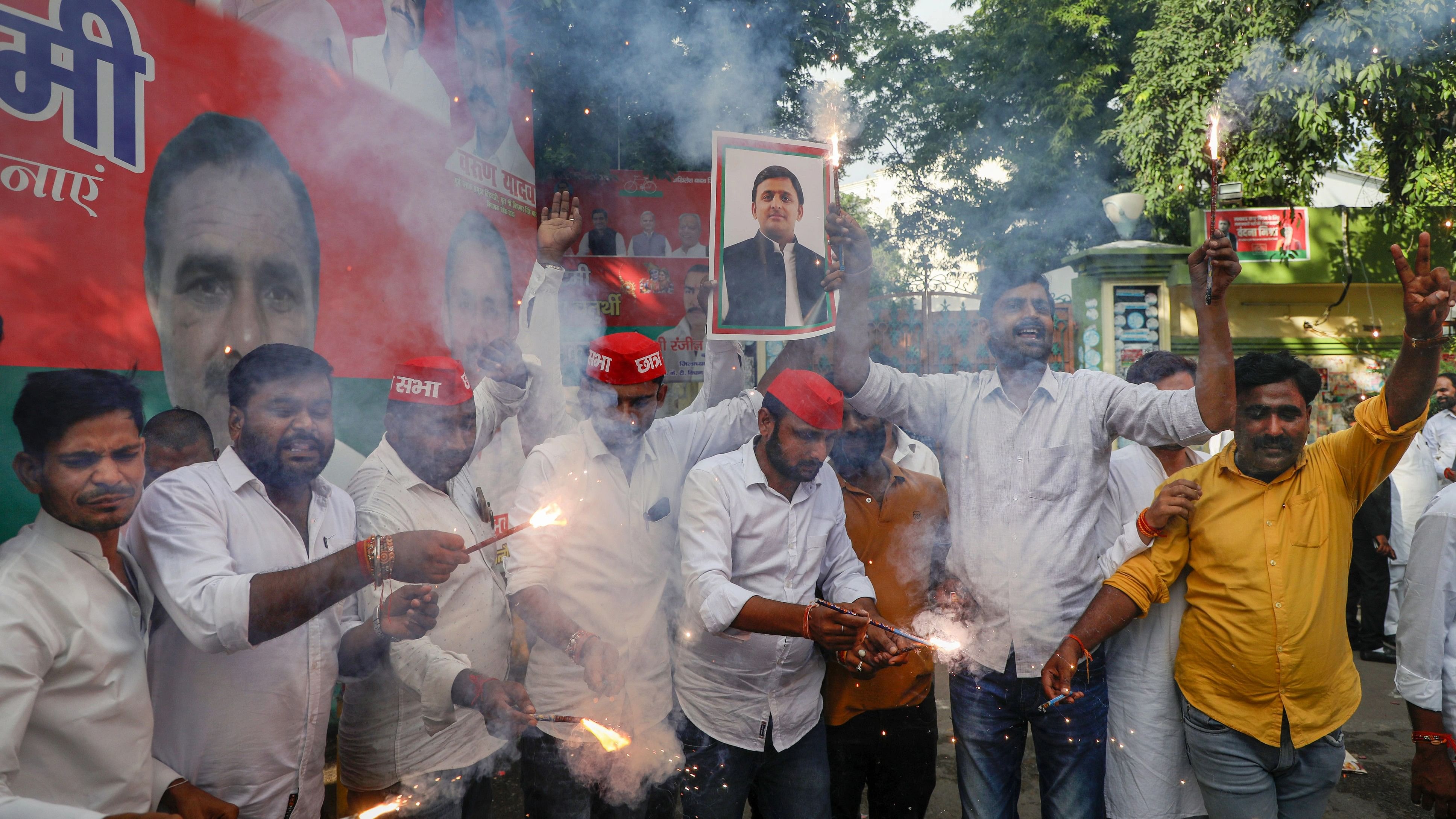 <div class="paragraphs"><p>Samajwadi Party workers celebrate the victory of party candidate Sudhakar Singh in the Ghosi constituency bypoll.</p></div>